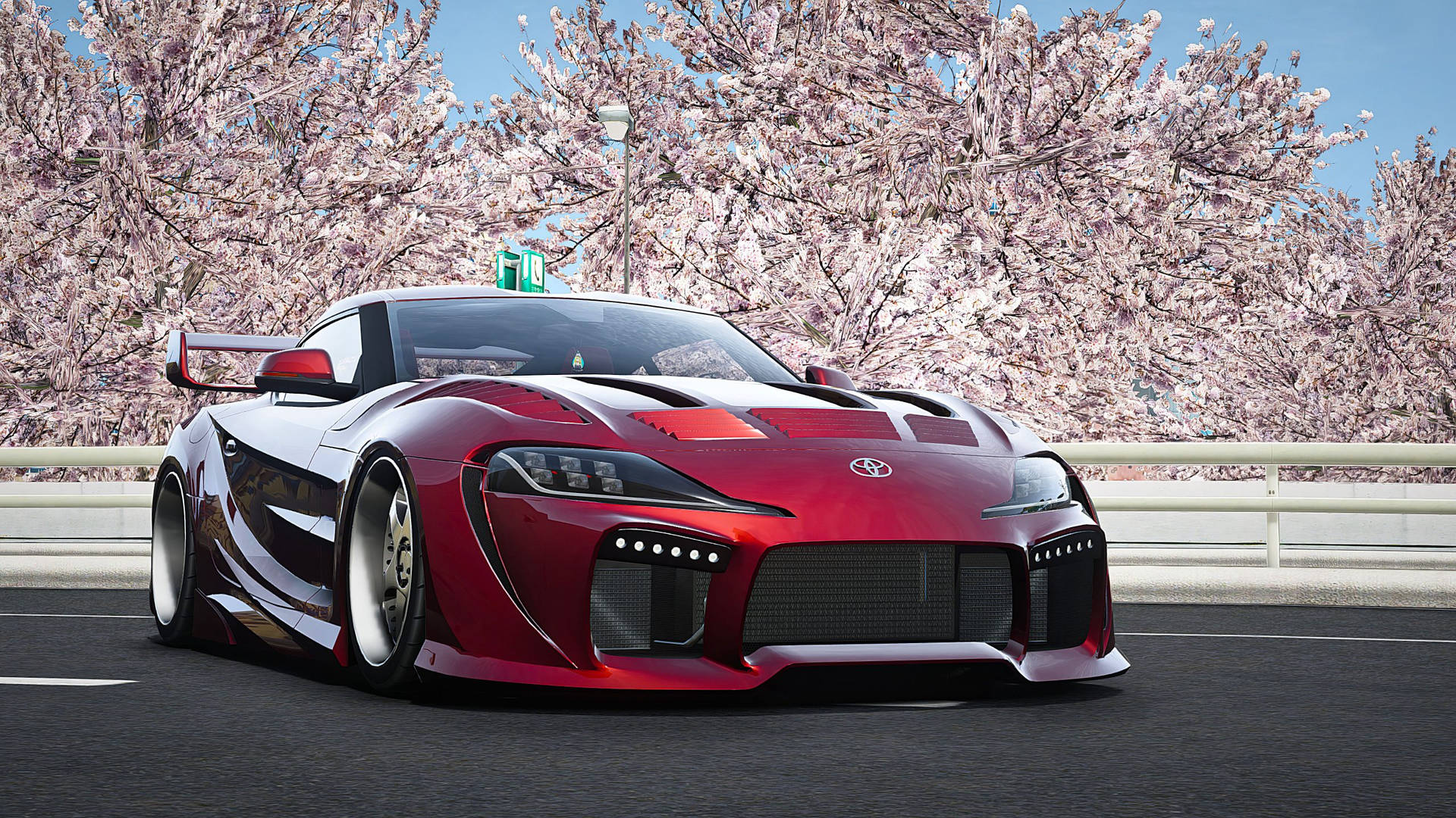紅色改裝豐田Supra在日落時分在櫻花樹下奔馳。 — Toyota Supra 壁紙