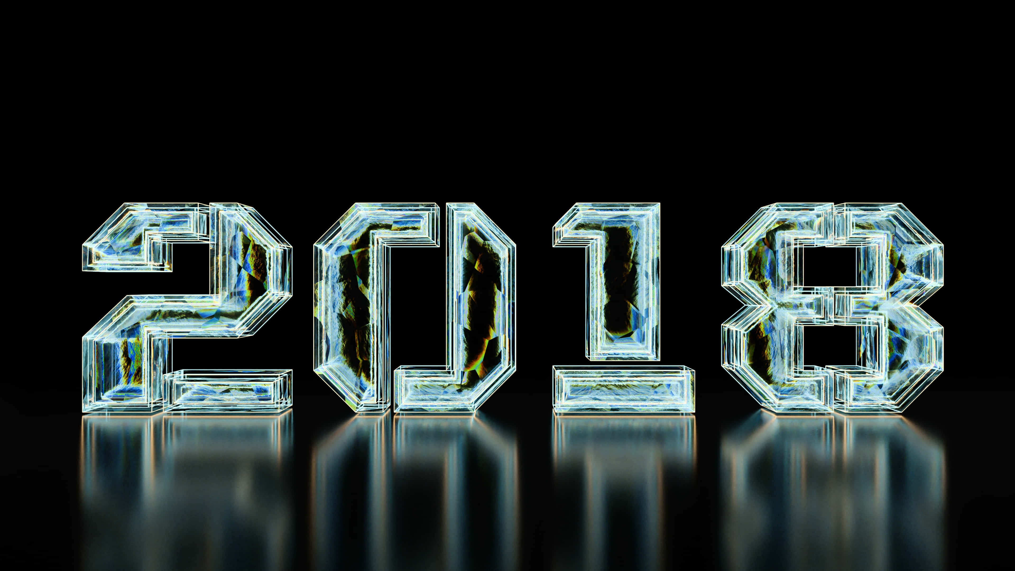 2018 桌布 壁紙 — 2018 年以發光半透明玻璃塊呈現，內部有裂紋和反射，置於黑色表面上。
