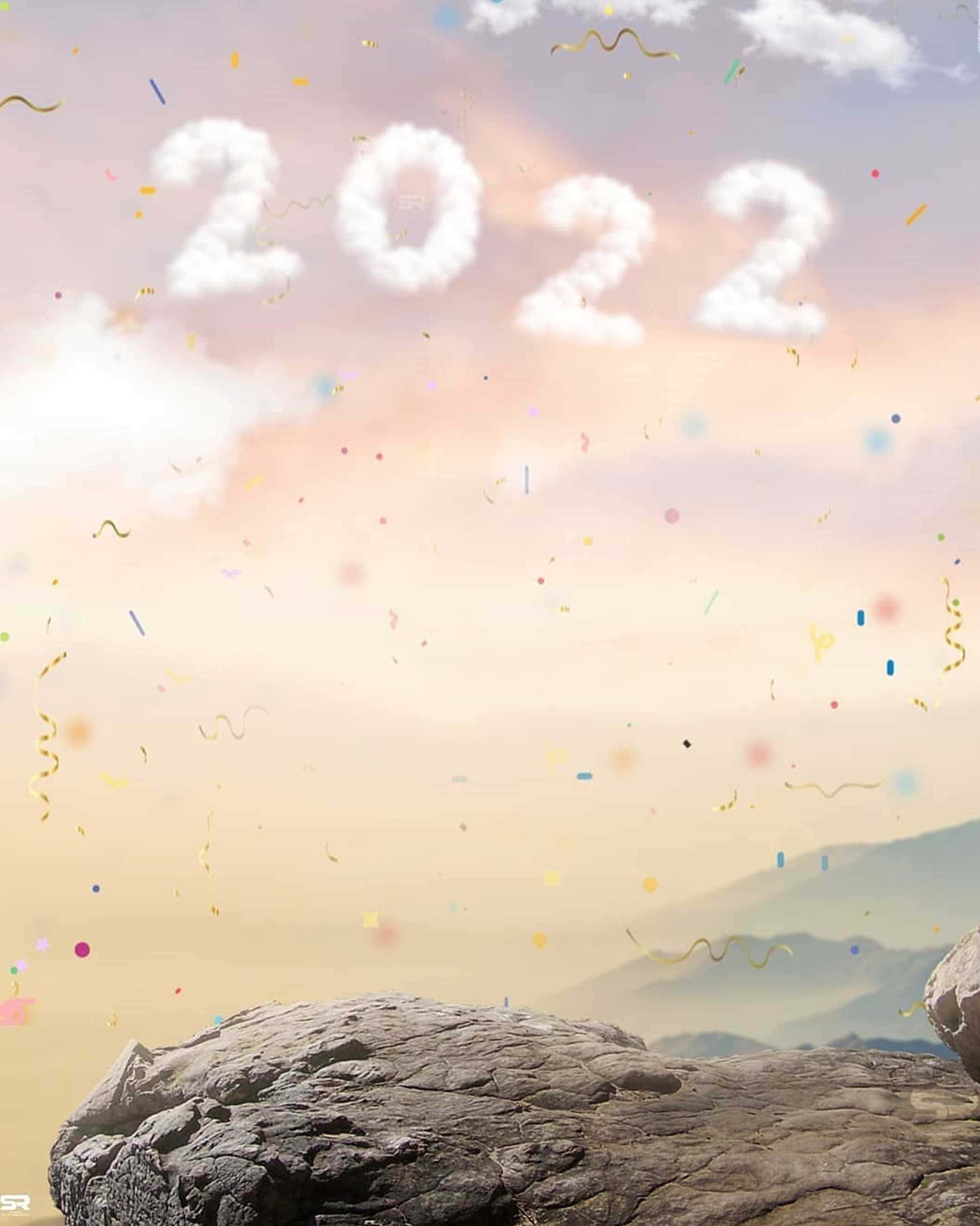 橘色 桌布 壁紙 — 2022形狀的雲漂浮在岩石懸崖上方，彩色紙屑在柔和粉彩天空下飄落。