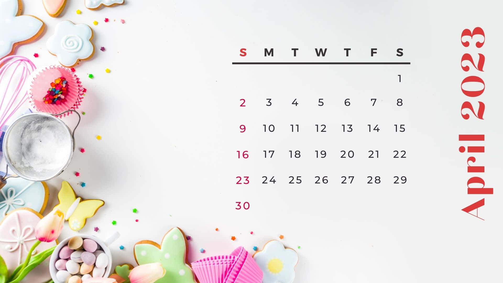 April 2023 Calendar 桌布 壁紙 — 2023年4月月曆，周圍是色彩繽紛的餅乾、糖粒和烘焙工具，放在乾淨的白色表面上。