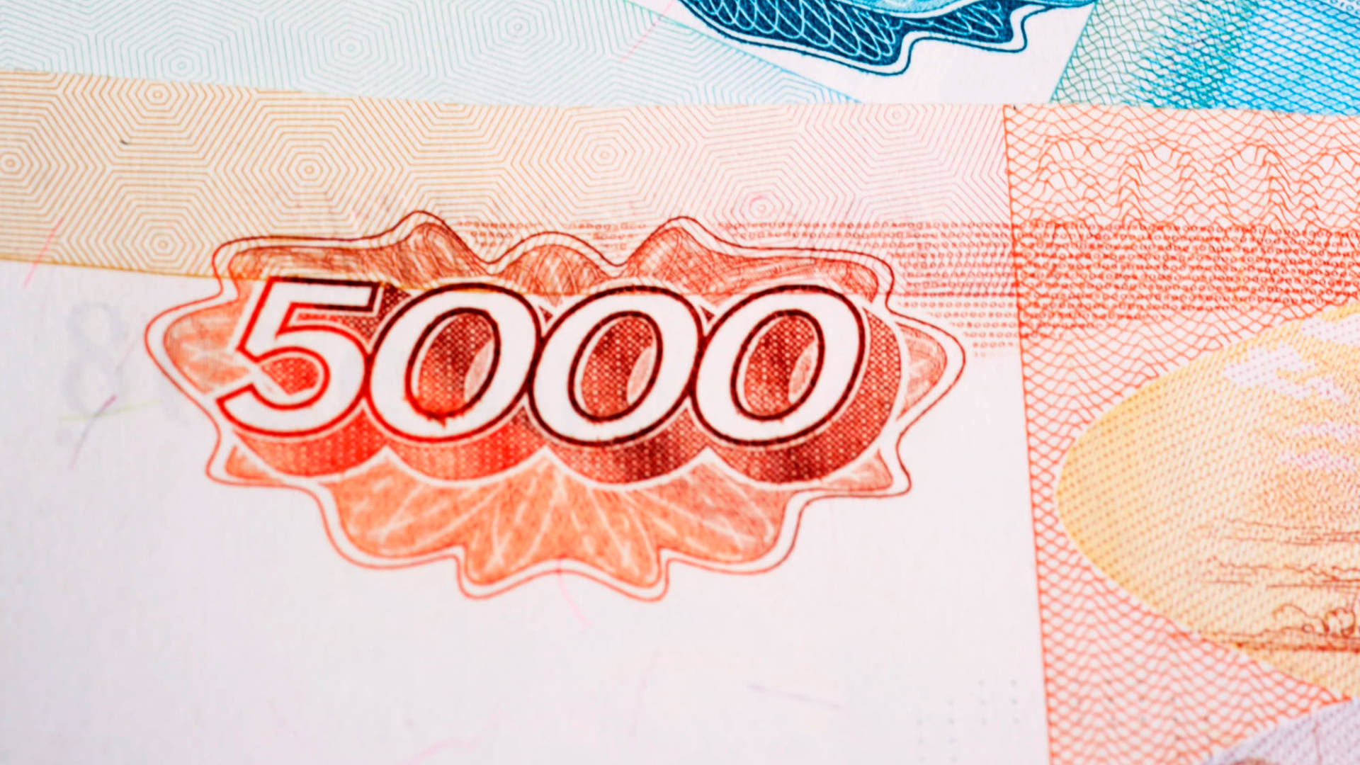 Bills 桌布 壁紙 — 5000元紙鈔特寫，顯示複雜的橙色和藍色安全圖案及浮雕數字。