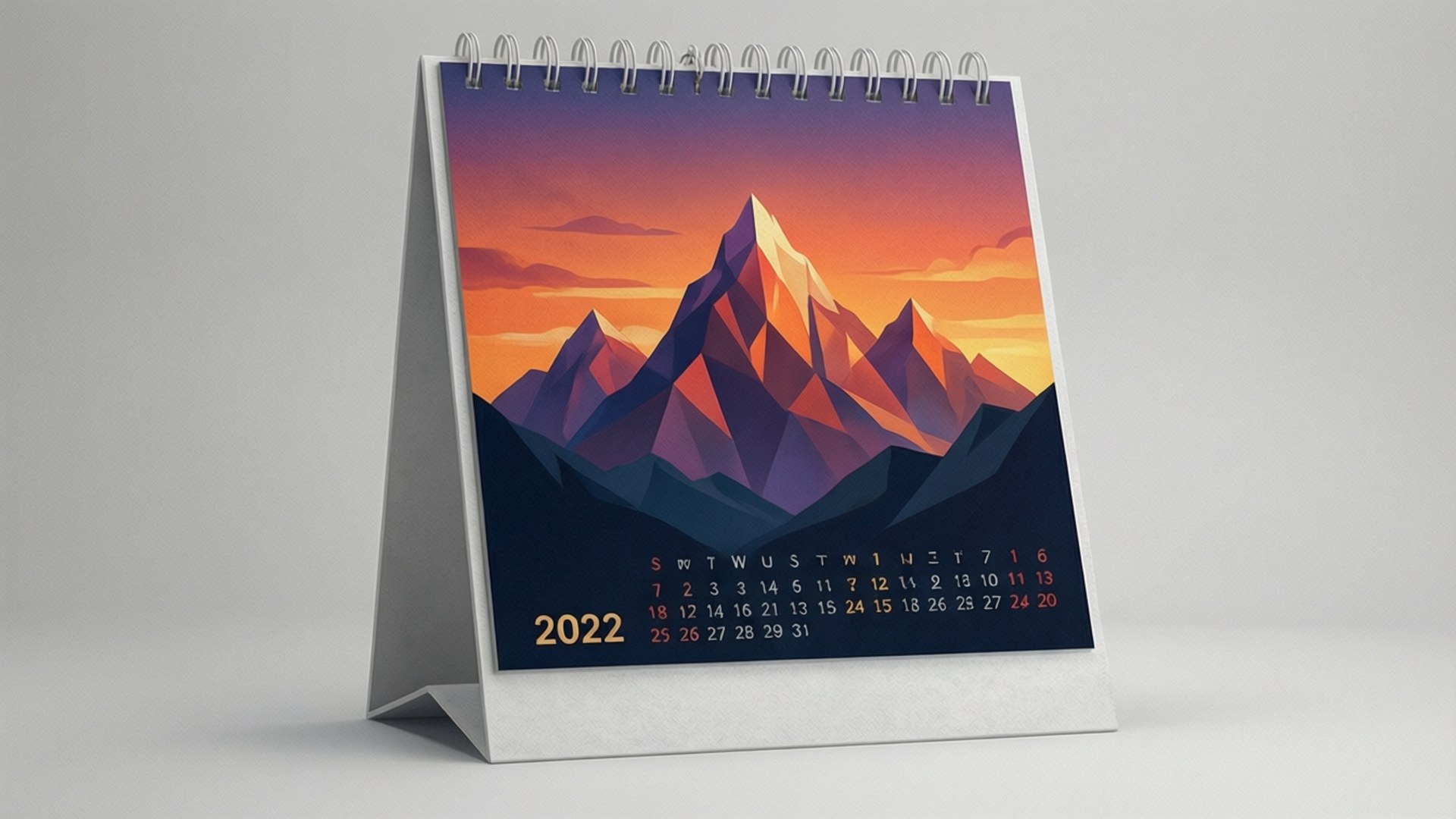 Geometric Mountain Calendar 2022 壁紙 — 2022年桌上日曆展示了一個風格化的山脈，在充滿活力的日落和幾何山峰及溫暖色調下。
