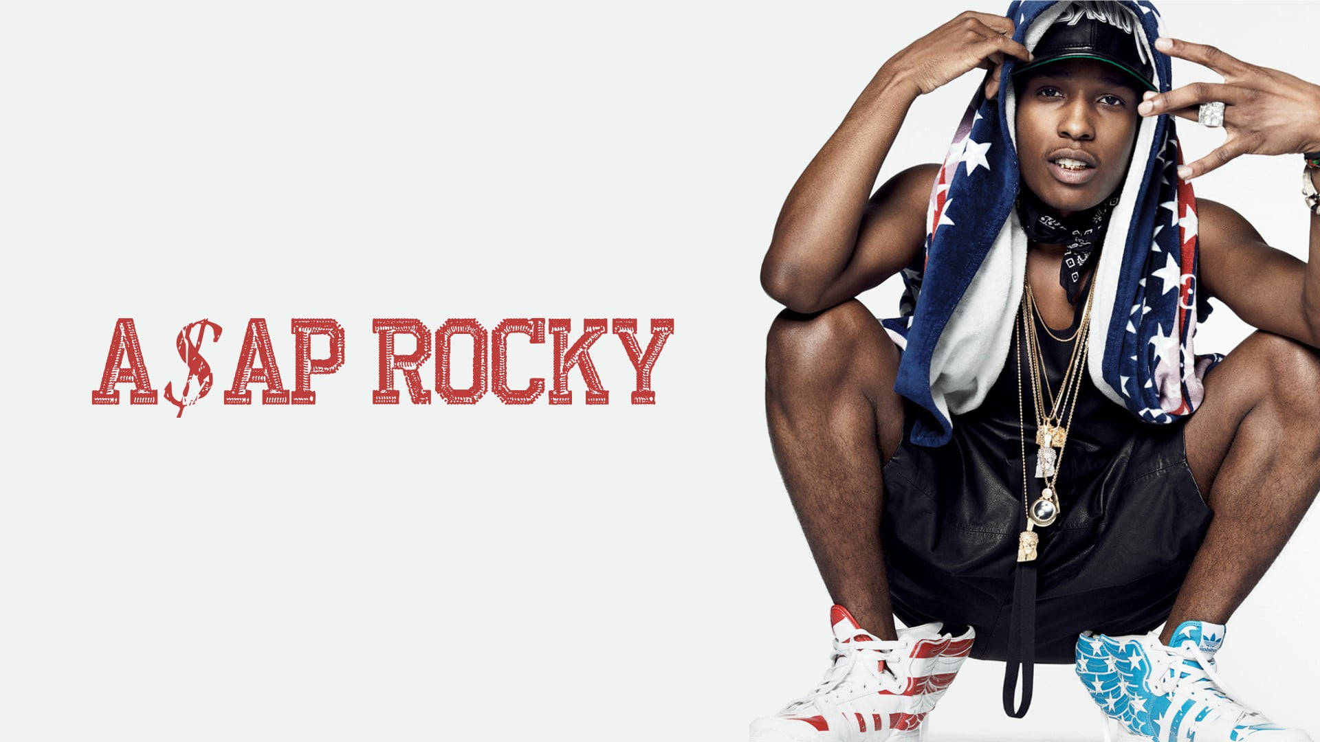 rocky 桌布 壁紙 — A$AP Rocky自信地蹲下，戴著愛國星條頭飾和運動鞋，背景簡潔，他的名字以紅色文字顯示。