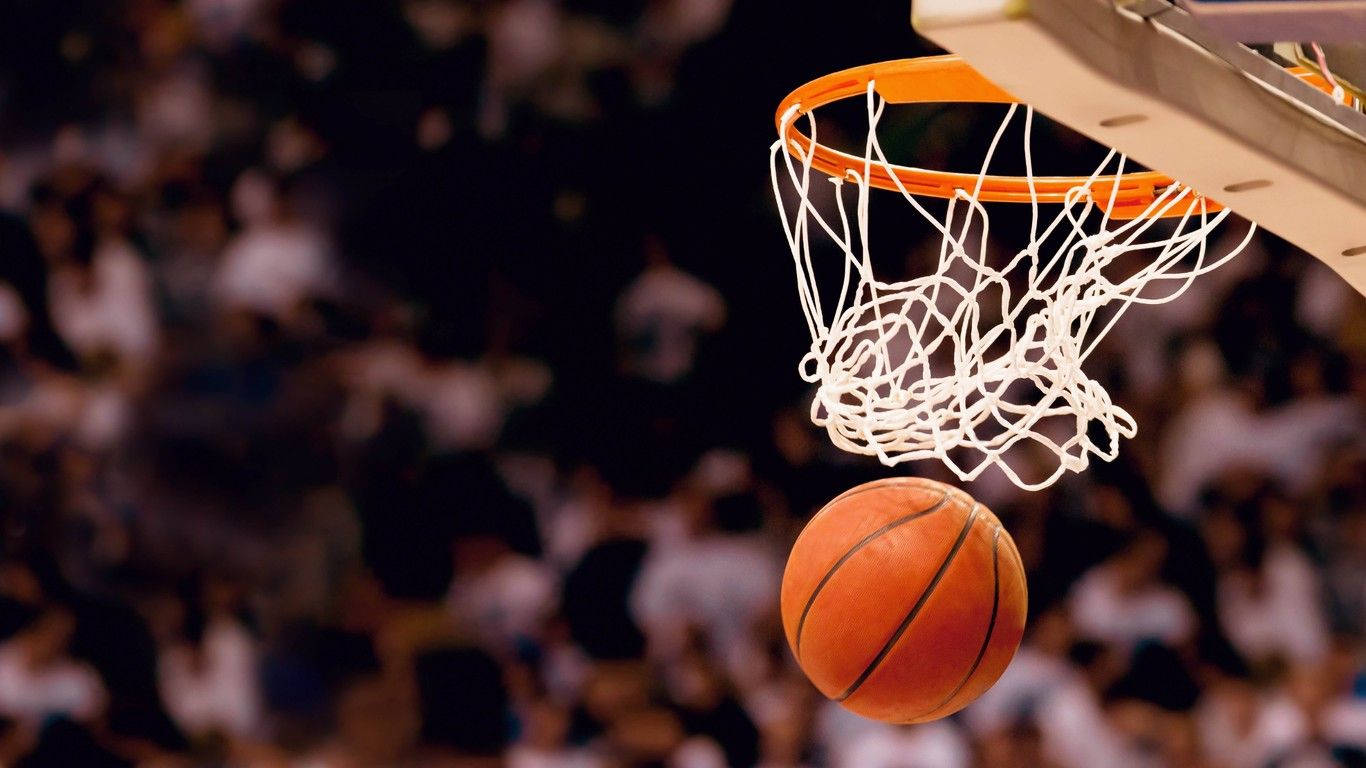 籃球靠近籃框，背景有人群。 — NBA 壁紙