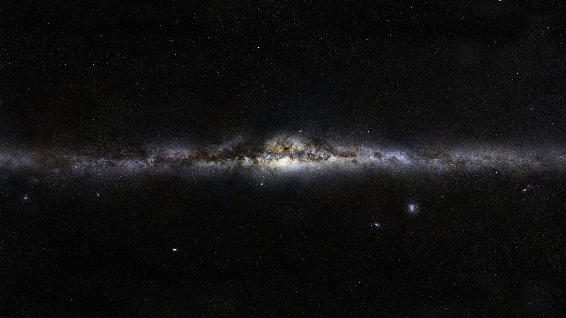 銀河系，帶有發光的星雲和黑暗的塵埃帶，背景是繁星點點的宇宙。 — 4K 太空 壁紙