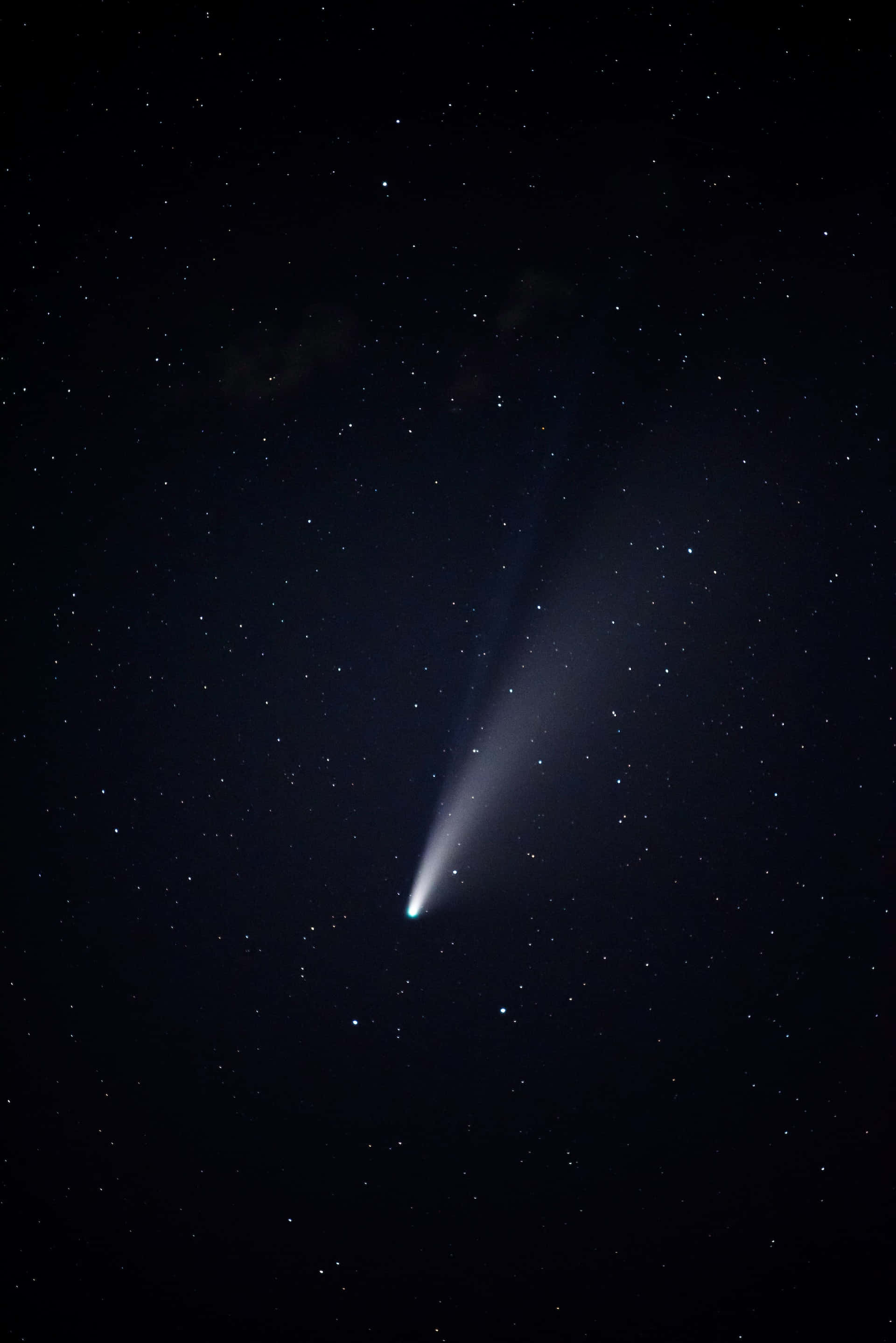 comet 桌布 壁紙 — 一顆明亮的彗星劃過繁星點點的夜空，帶有發光的尾巴和背景中的黑暗星雲。