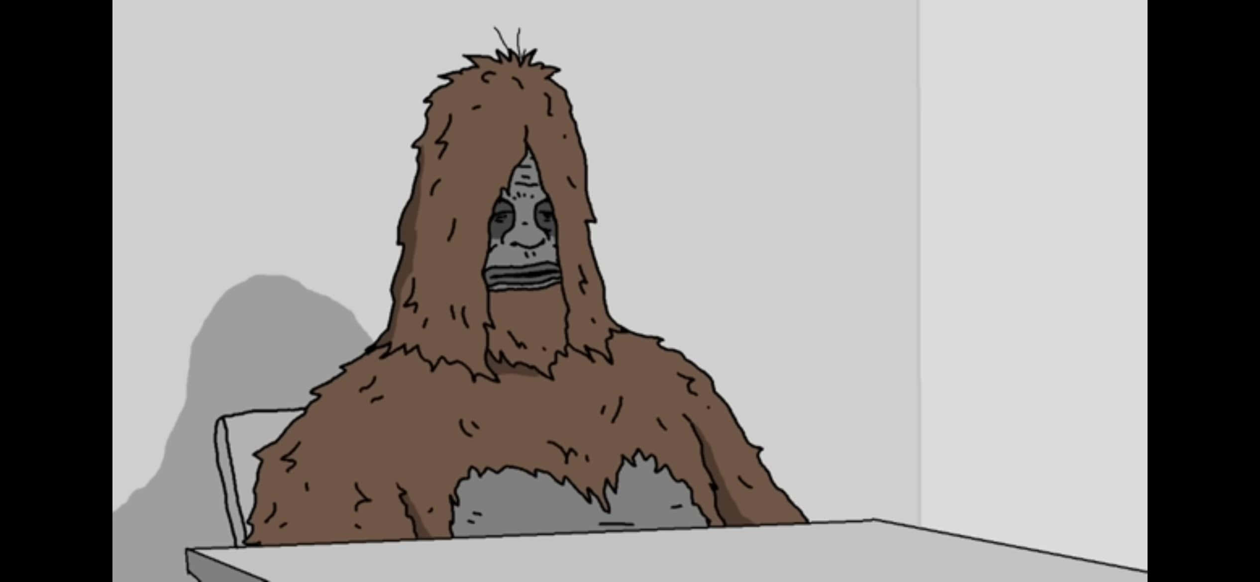 Sassy The Sasquatch 桌布 壁紙 — 一個卡通大腳怪坐在一張桌子旁，房間簡約，牆壁樸素，背後有陰影。