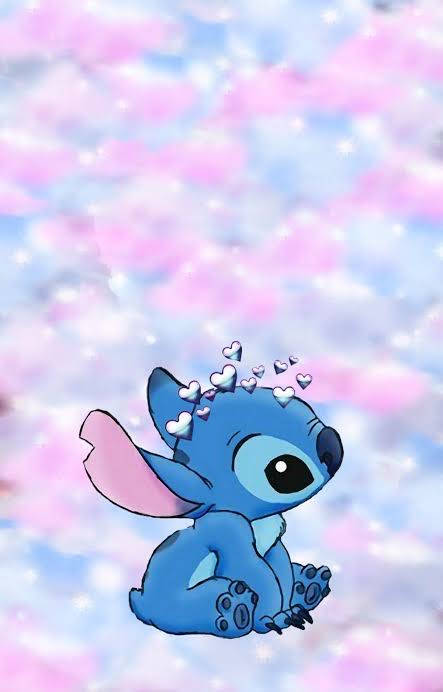 藍色外星人，粉紅色耳朵，被漂浮的心形環繞在粉彩天空。 — Stitch 壁紙