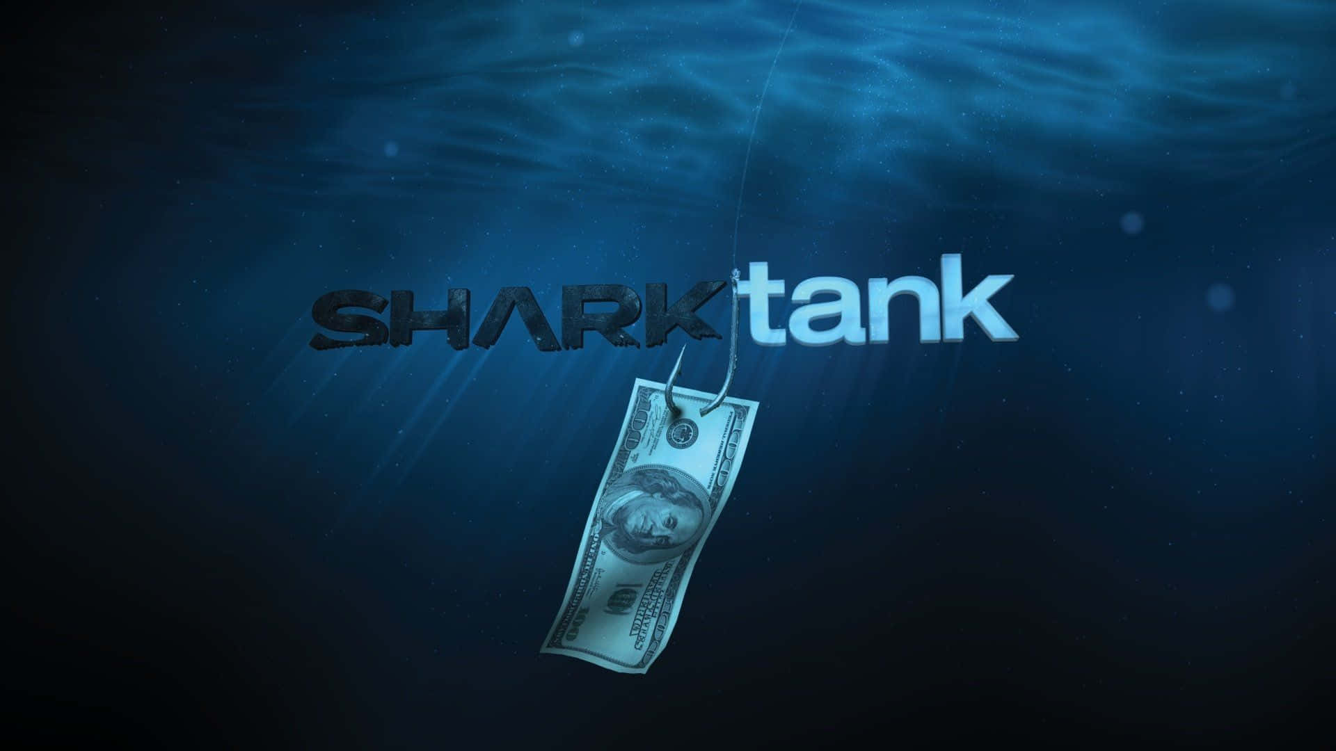  壁紙 — 一張一美元鈔票掛在魚鉤上，在深藍色水中懸掛在「SHARKtank」標誌下方。