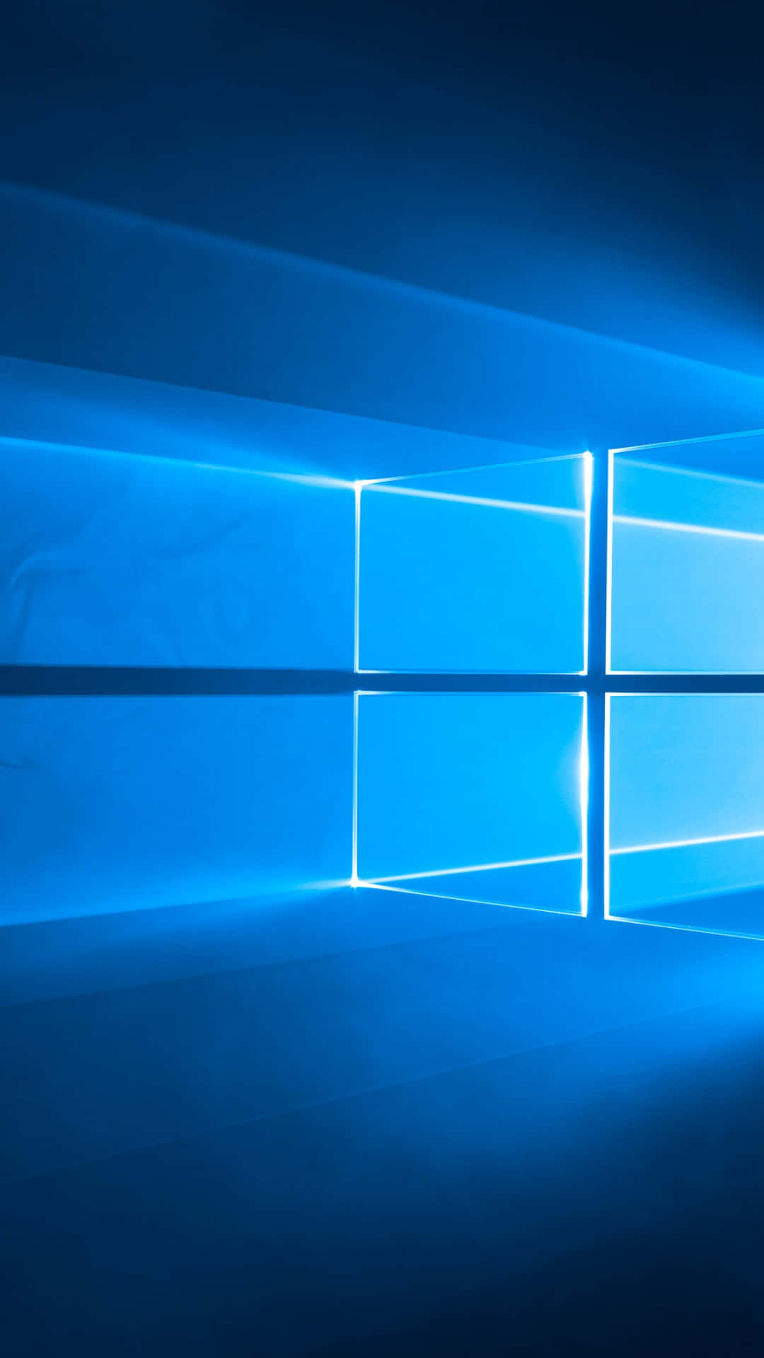 一扇發光的藍色窗戶，光線投射在深藍色背景上。 — Windows 11 壁紙