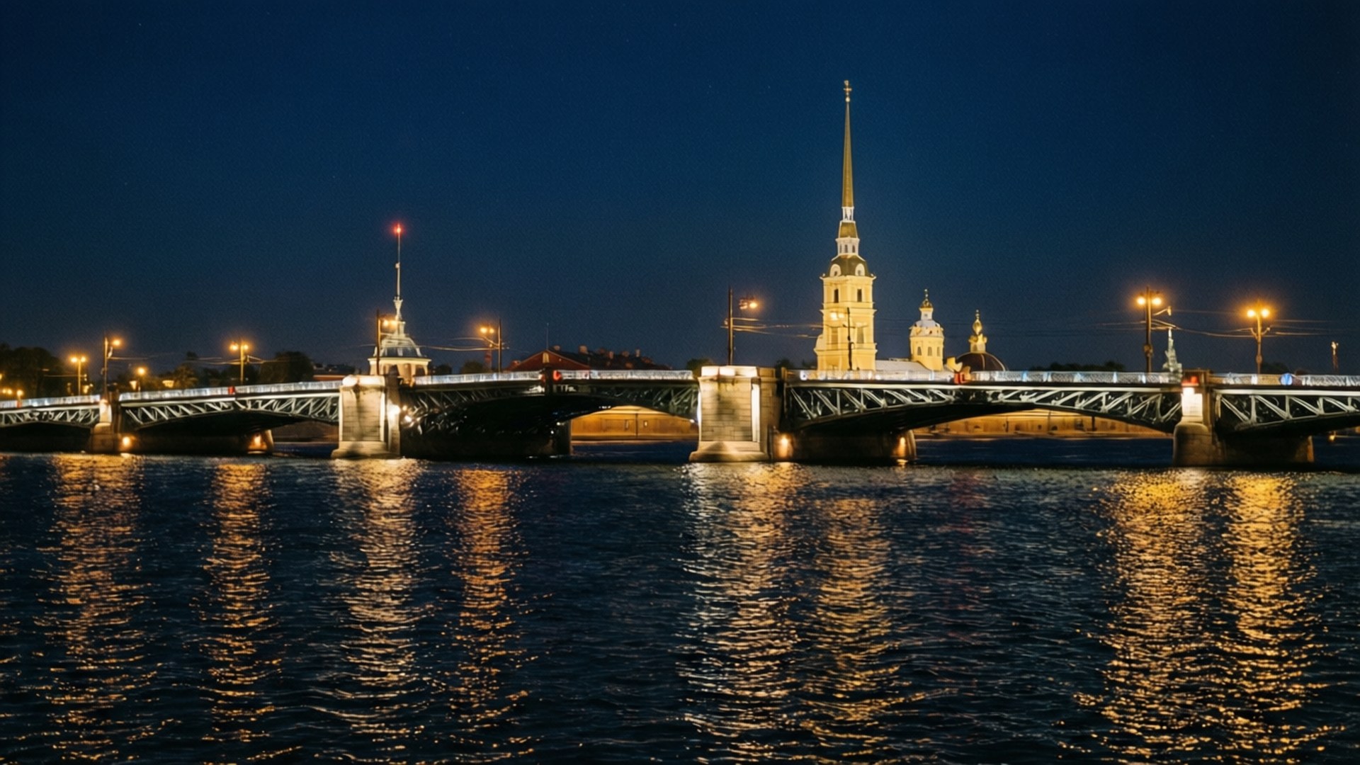 Bridge of Lights 壁紙 — 一座宏偉的照明橋樑橫跨夜晚的黑暗河流，金色的燈光倒映在水面上，背景中有一座高聳的尖頂教堂在發光。