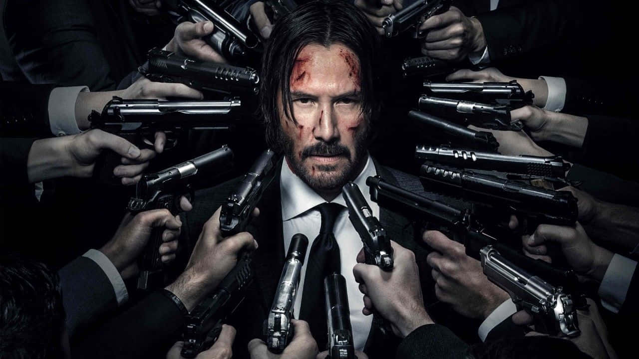滿臉是血的男人，被許多看不見的手持槍包圍。 — John Wick 壁紙