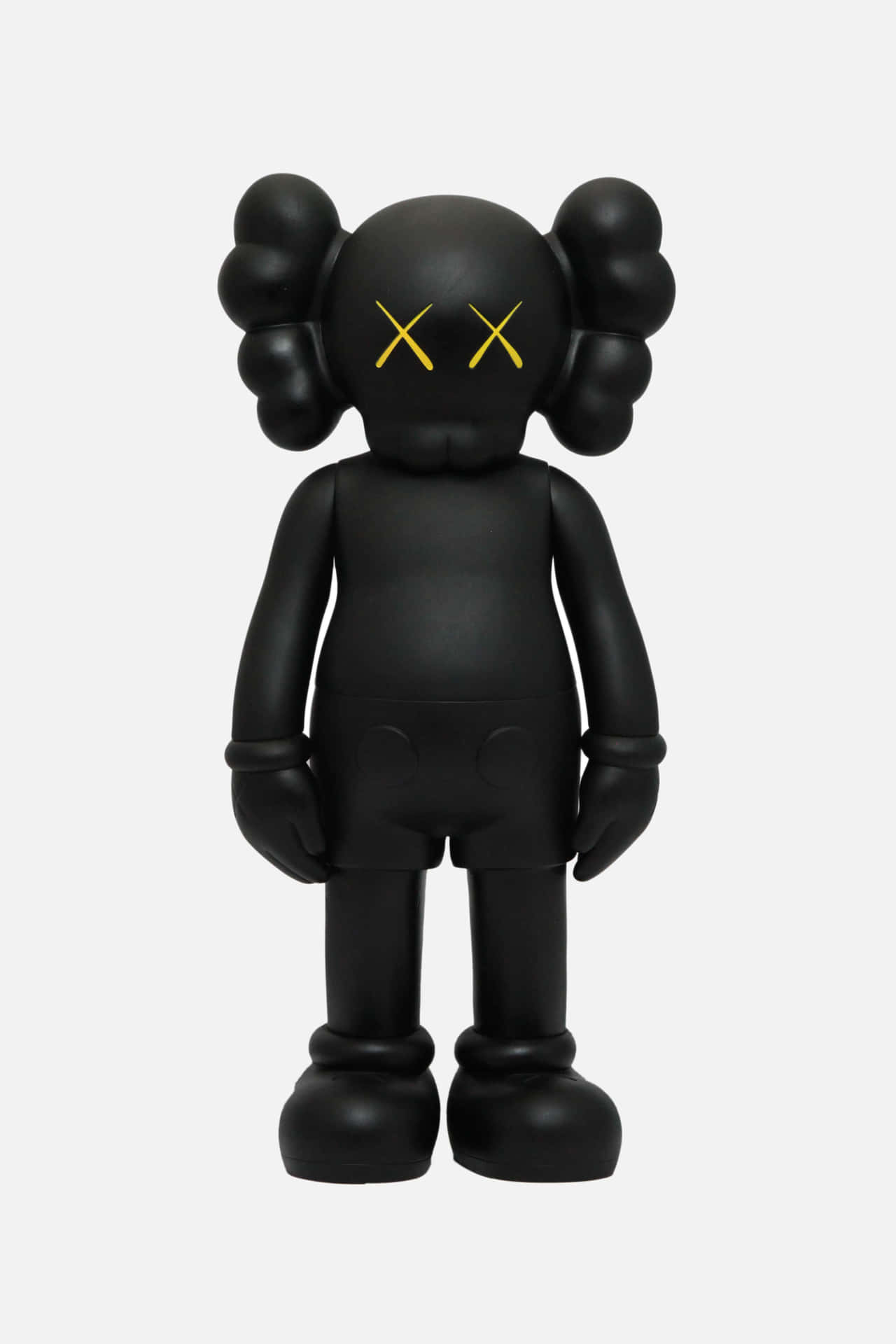 帶有黃色X眼睛的黑色KAWS Companion公仔靜止站立。 — Kaws 壁紙