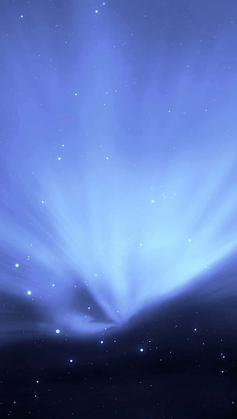  壁紙 — 一道耀眼的藍色宇宙爆發，以柔和的光芒照亮了星場，背景是黑暗的星雲。