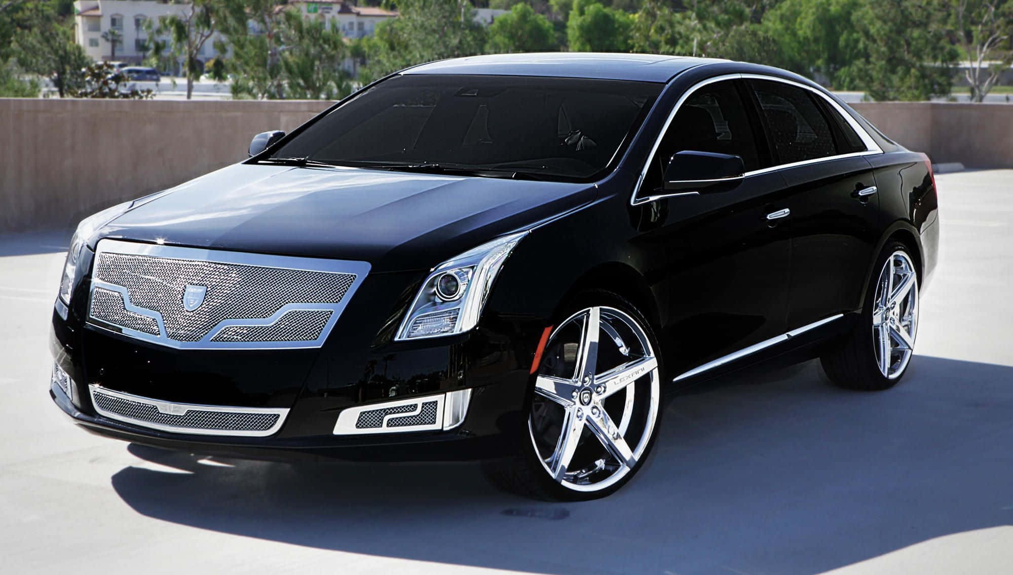 Cadillac Xts 桌布 壁紙 — 一輛時尚的黑色 Cadillac XTS 豪華轎車，帶有鍍鉻飾邊和定制輪圈，停在陽光照射的混凝土表面上。