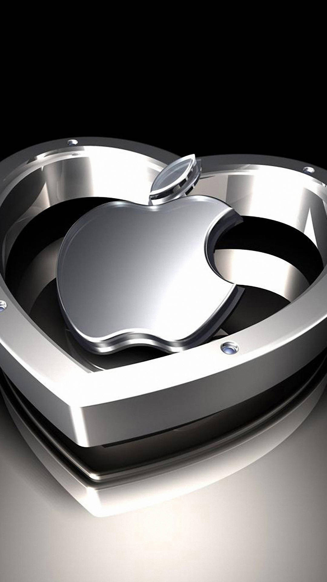 閃亮的銀色 Apple 標誌位於心形金屬框架內。 — 3D 壁紙