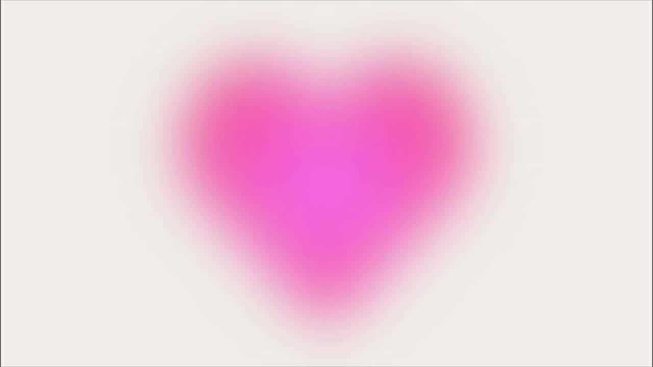  壁紙 — 一顆柔和發光的粉紅色心臟，在淺色背景上以溫和的漸變模糊效果散發溫暖。