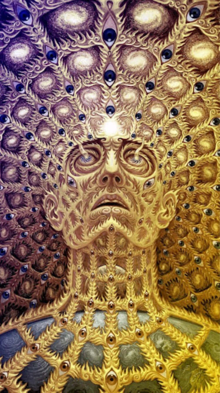  壁紙 — 一個超現實的金色面孔，帶有複雜的圖案和嵌入的眼睛，在宇宙紫色和金色背景下散發神聖能量。