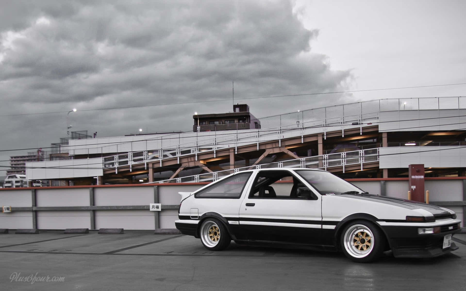 白色和黑色的AE86跑車停放在多層停車場。 — Toyota Supra 壁紙