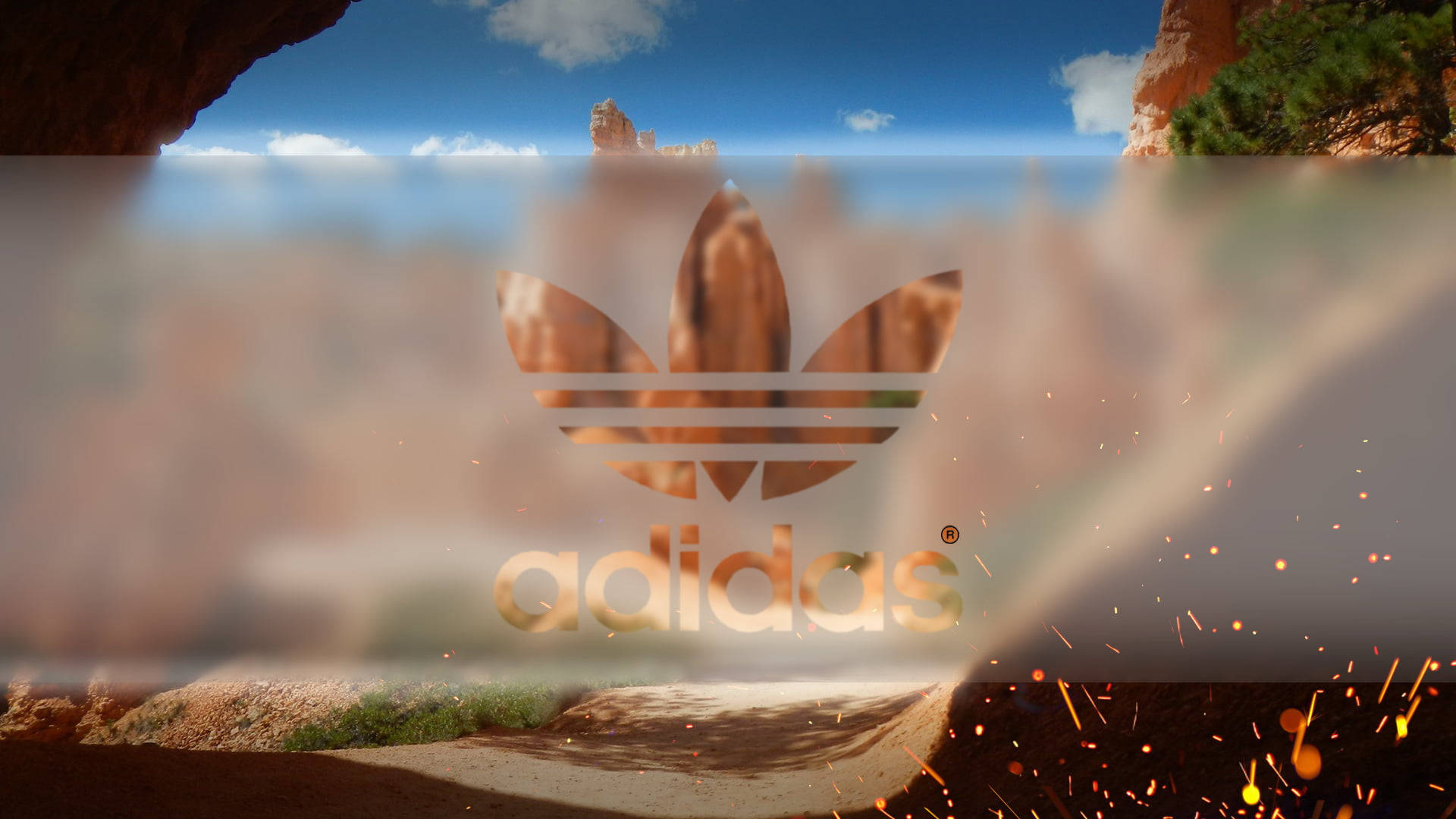 愛迪達 桌布 壁紙 — Adidas 標誌疊加在沙漠峽谷場景上，底部有火花飛濺。