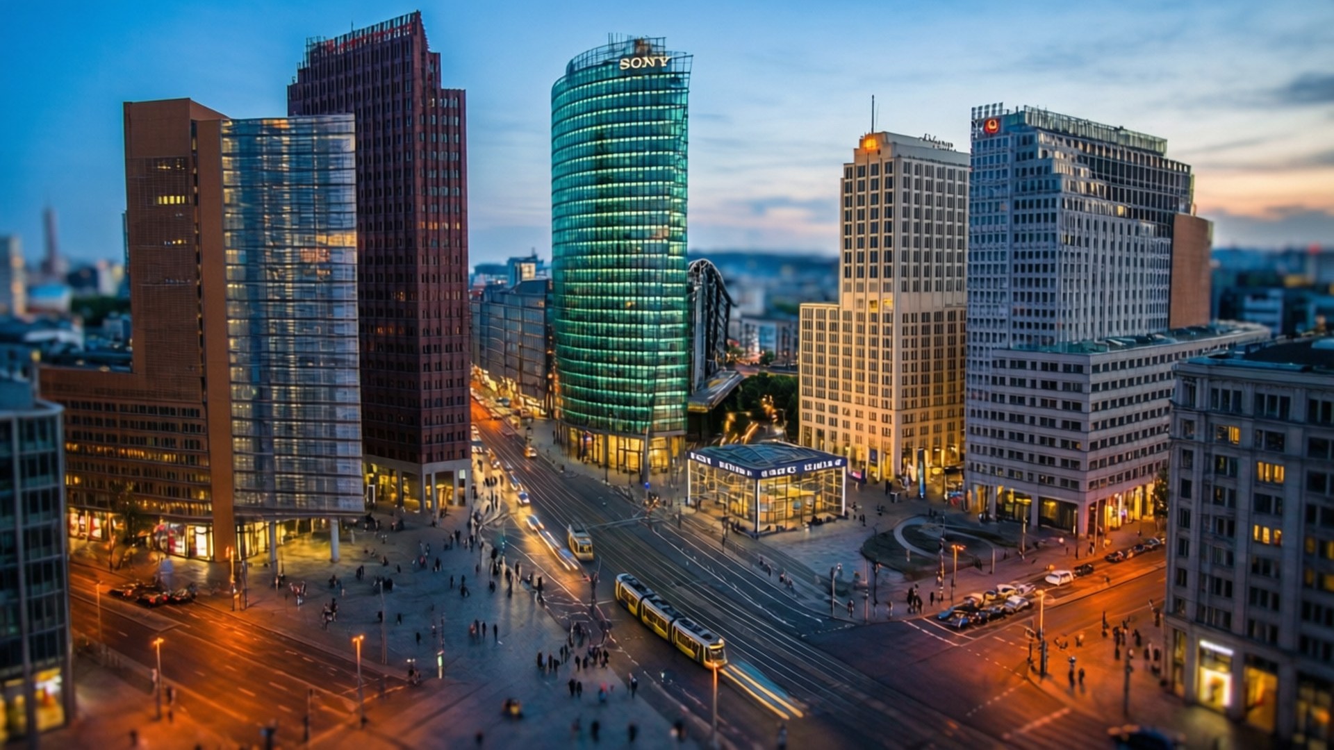 Potsdamer Platz Dusk 壁紙 — 黃昏時分繁忙城市景觀的鳥瞰圖，高聳的摩天大樓在暮色天空下閃耀。