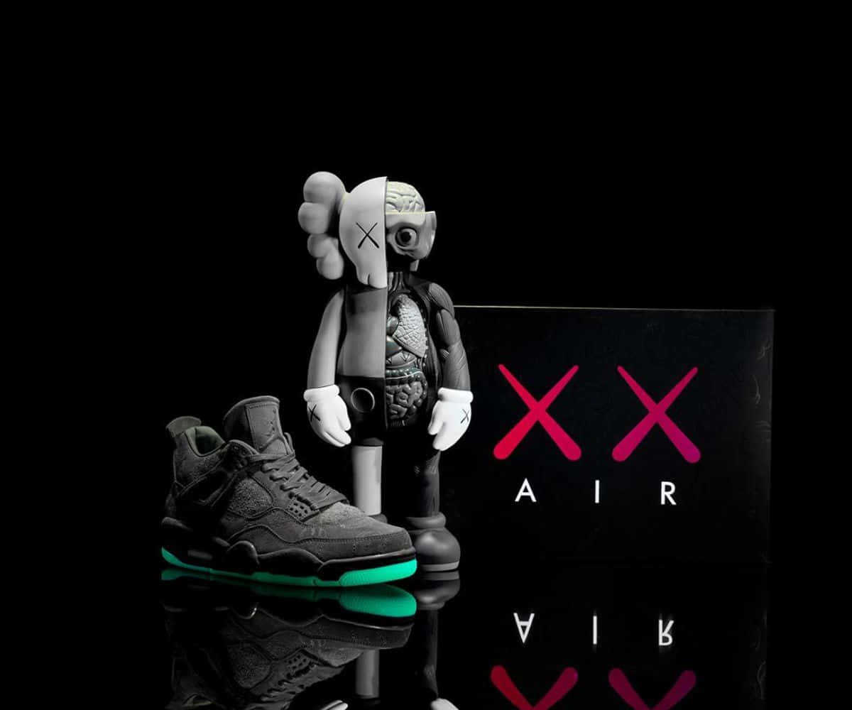 Kaws X Air Jordan 桌布 壁紙 — AKA kaws 公仔內臟外露，站在一雙黑色運動鞋旁邊，鞋底發出綠色螢光，置於反光表面上。