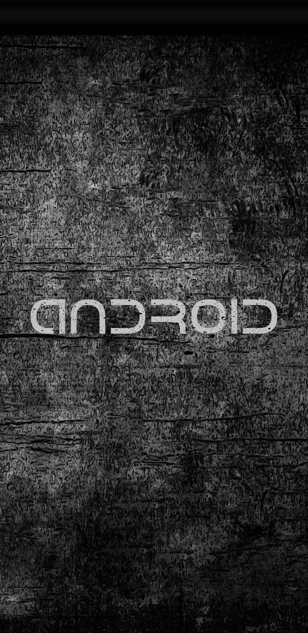 安卓 桌布 壁紙 — Android 標誌以反白文字顯示在帶有粗糙污垢的深色紋理混凝土牆上。