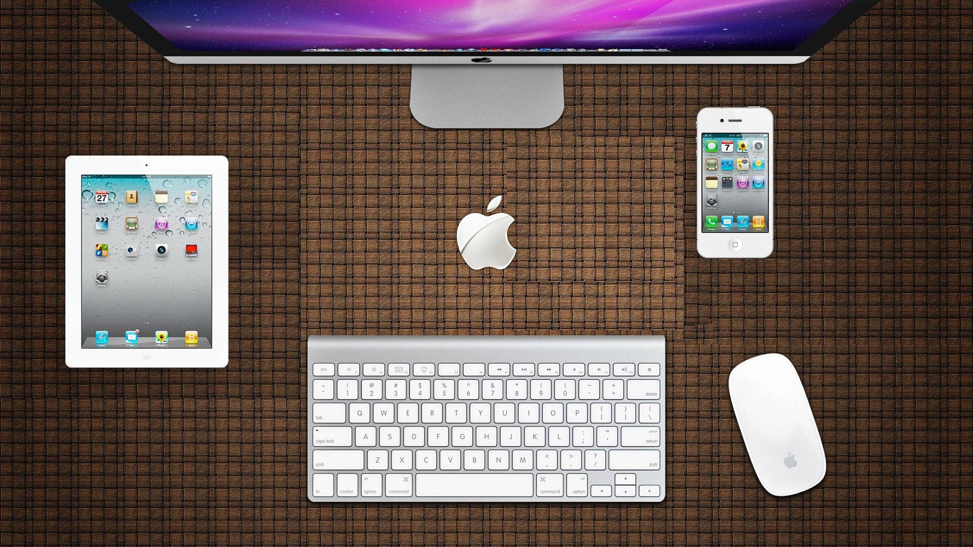 蘋果 桌布 壁紙 — Apple 裝置（包括顯示器、平板電腦、電話、鍵盤和滑鼠）在棕色編織滑鼠墊上的俯視圖。