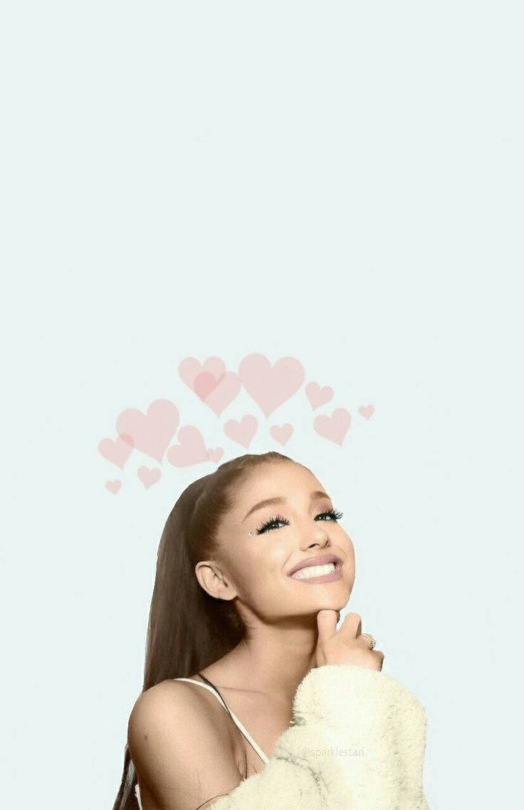 Grande 桌布 壁紙 — Ariana Grande 在柔和的淺藍色背景上，頭頂漂浮著粉紅色心形，開心地微笑。