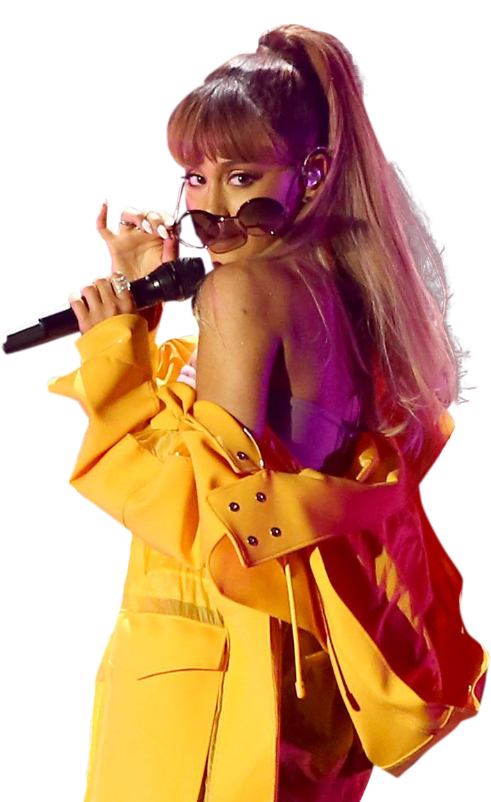 亞莉安娜·格蘭德 桌布 壁紙 — Ariana Grande 在舞台上以鮮黃色服裝、超大太陽眼鏡和高馬尾造型，在絢麗的舞台燈光下表演。