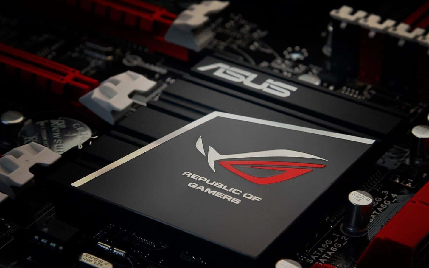 ASUS 桌布 壁紙 — ASUS ROG 主機板特寫，帶有紅色和黑色點綴，在戲劇性燈光下可見電路。