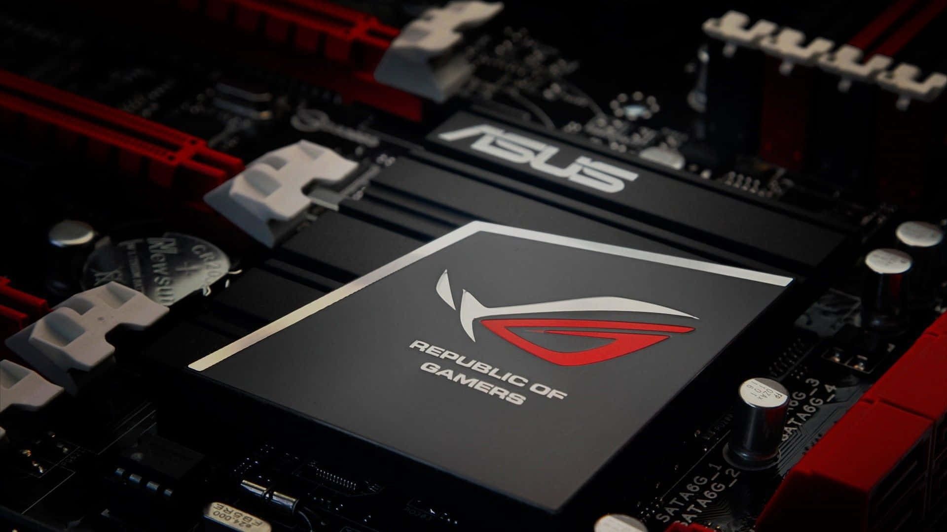 華碩 ROG 桌布 壁紙 — ASUS ROG 主機板特寫，紅色和黑色組件在戲劇性燈光下。