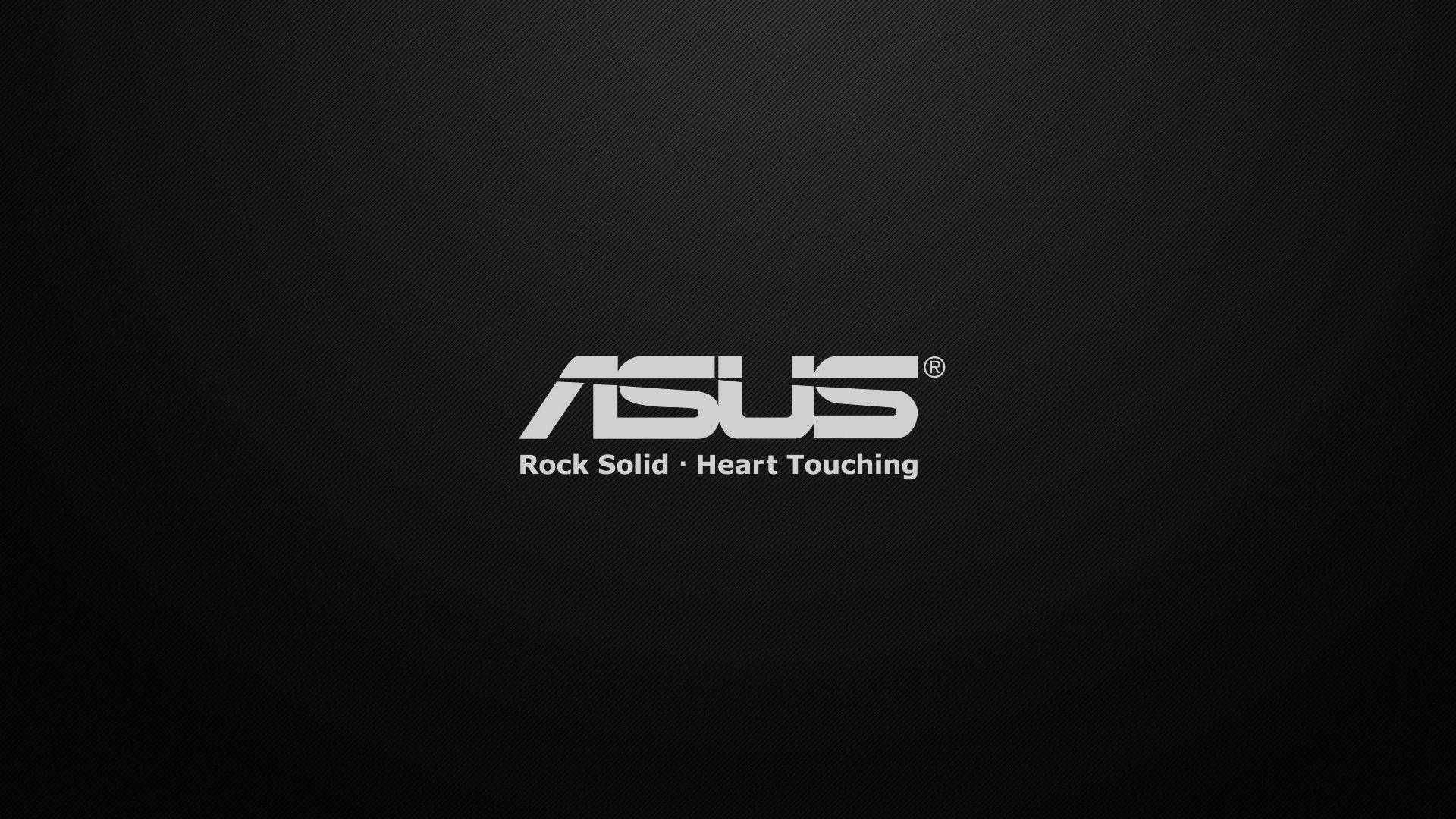 Solid 桌布 壁紙 — ASUS 標誌以銀色文字呈現於深色紋理黑色背景上，附有標語 rock solid heart touching。