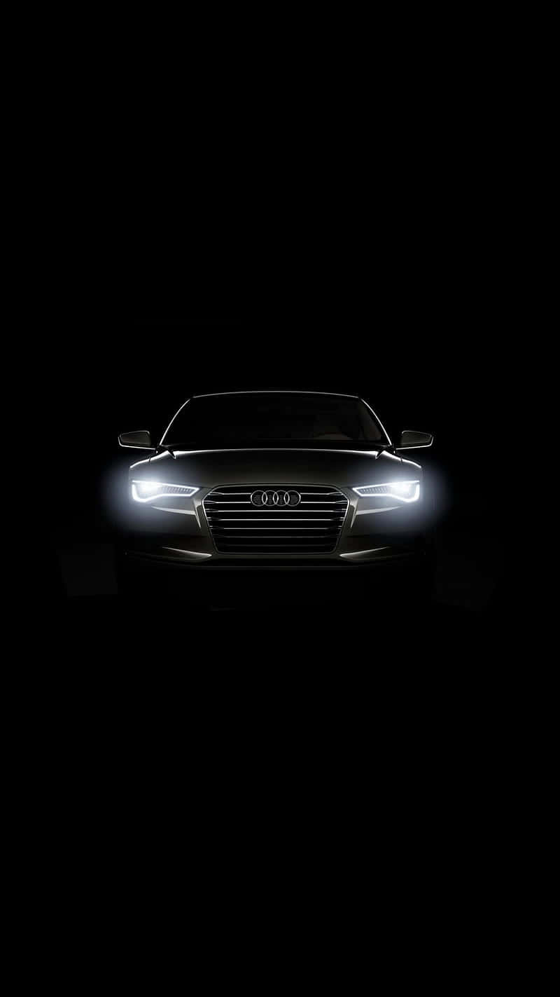 Audi iPhone 桌布 壁紙 — Audi 車頭視圖，頭燈在純黑色背景上發光。