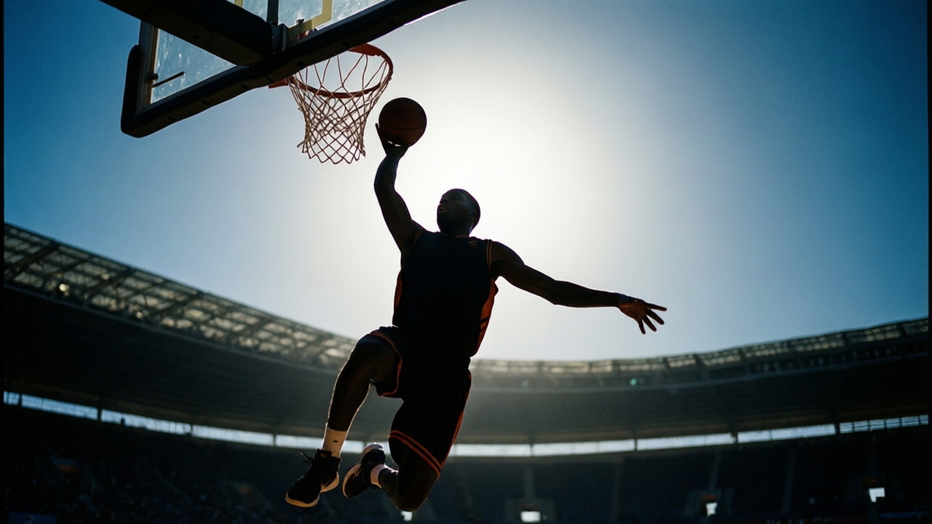 Dunk in the Light 壁紙 — 一個籃球運動員在太陽的剪影下，在空無一人的體育館中灌籃。