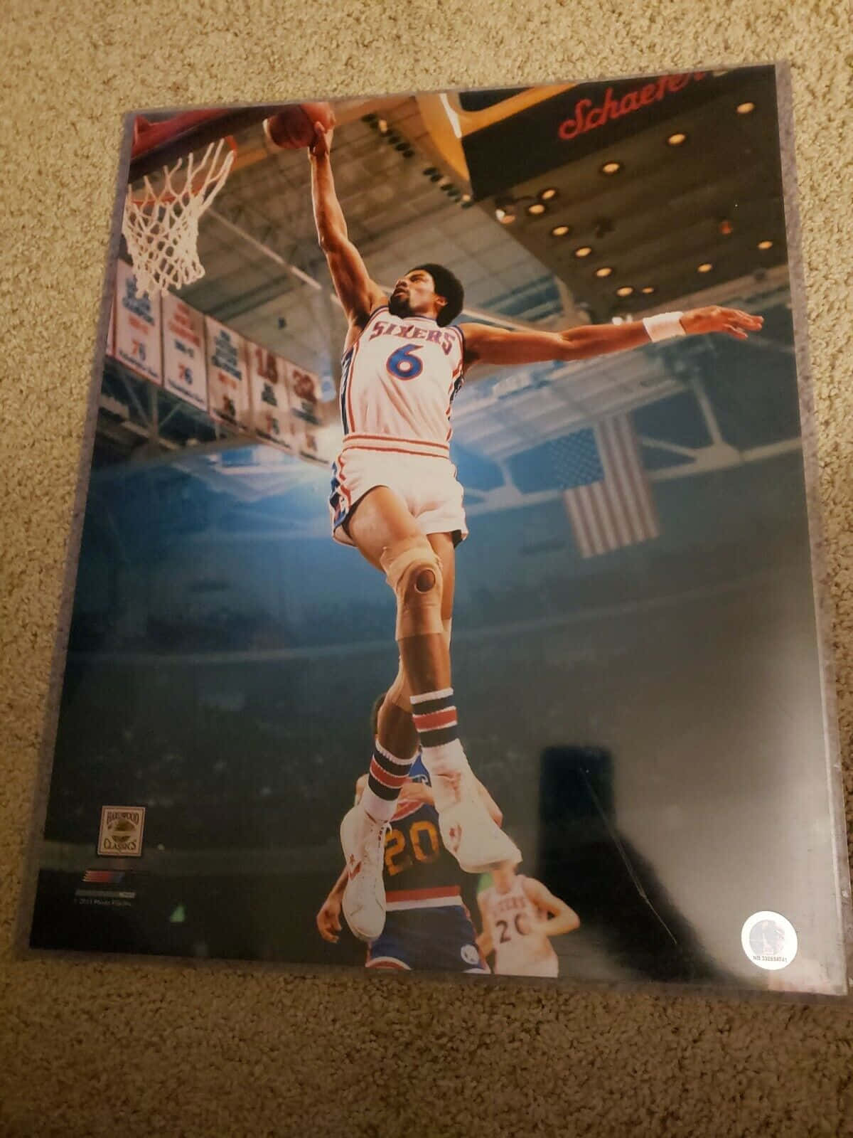 身穿白色Sixers球衣背號6的籃球運動員在場館中灌籃。 — NBA 壁紙