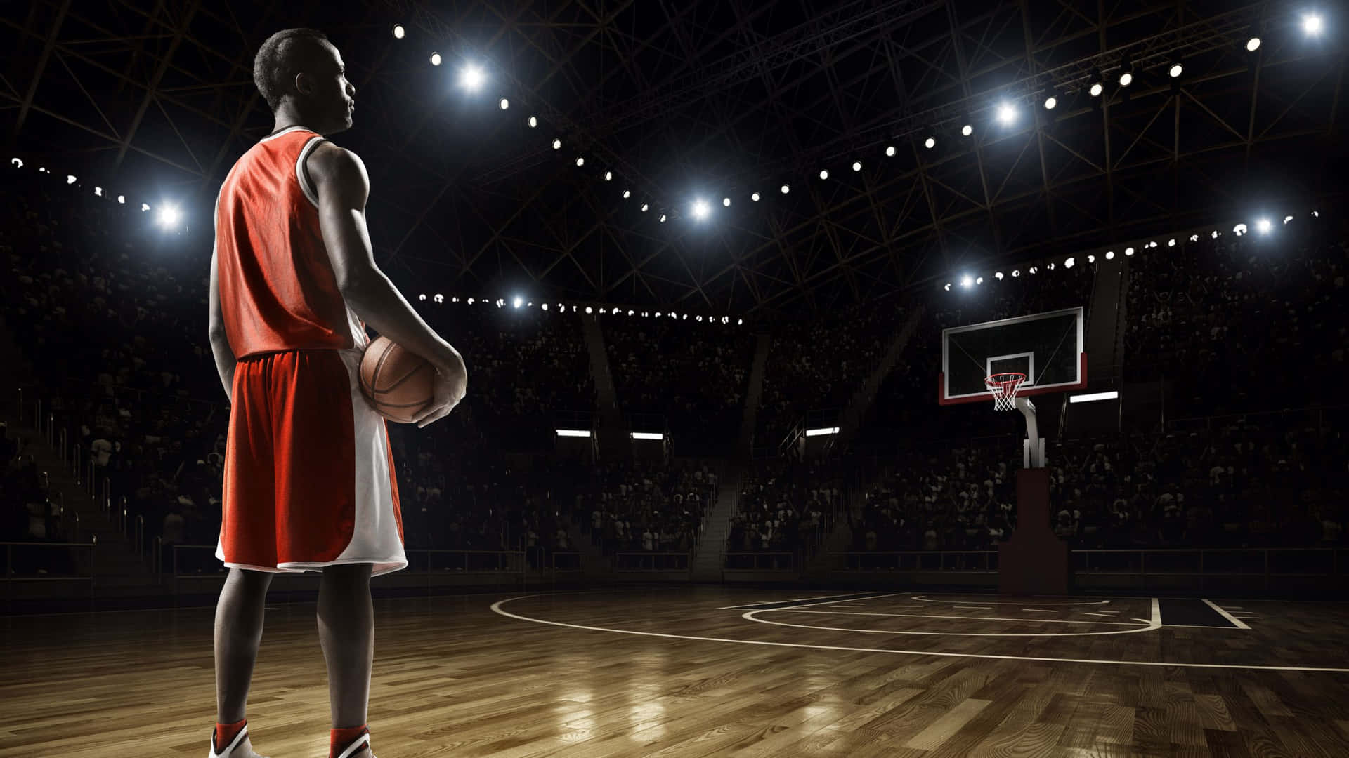 身穿紅色球衣的籃球運動員在明亮的球場上持球面向籃框。 — NBA 壁紙