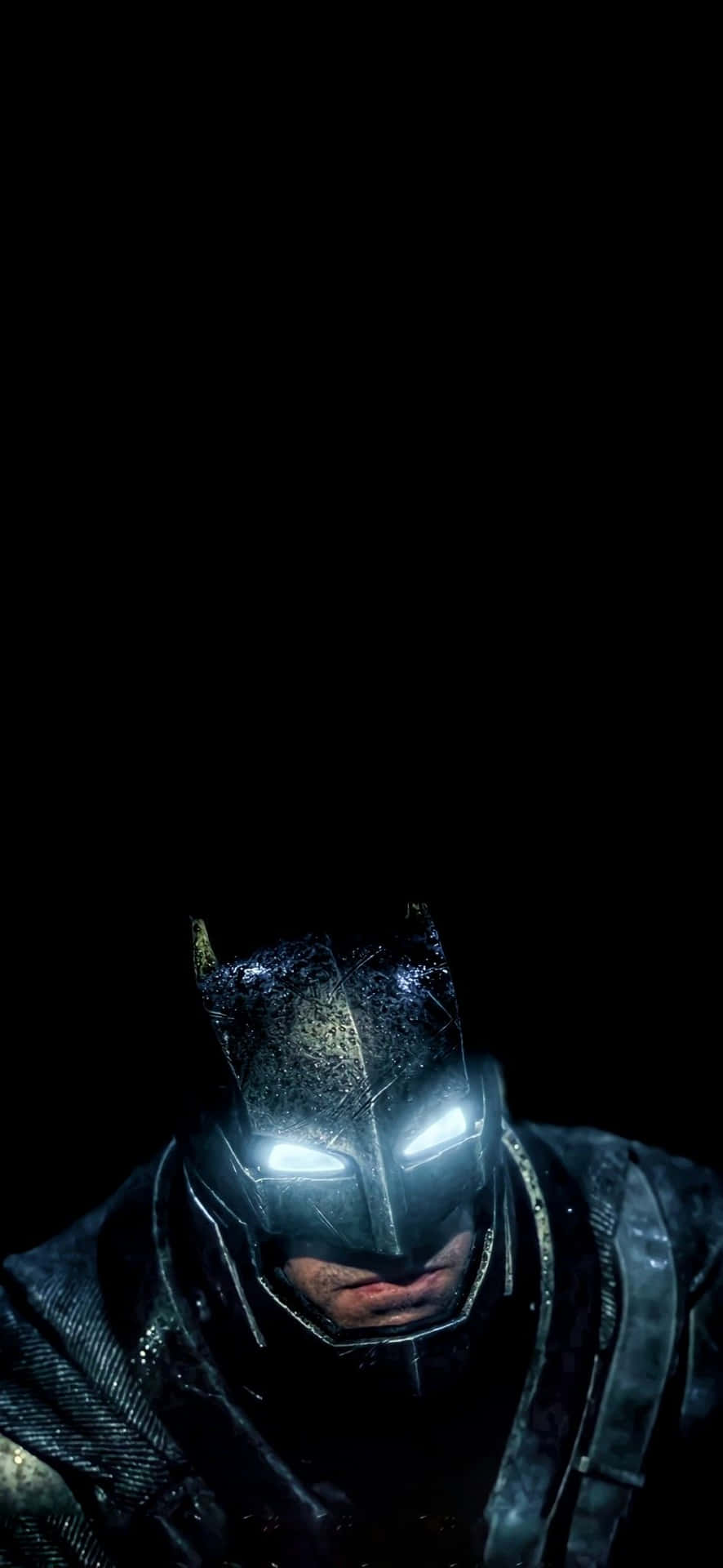  壁紙 — 蝙蝠俠發光的眼睛刺穿黑暗，雨水順著他骯髒的頭罩流下，營造出充滿氛圍的特寫鏡頭。