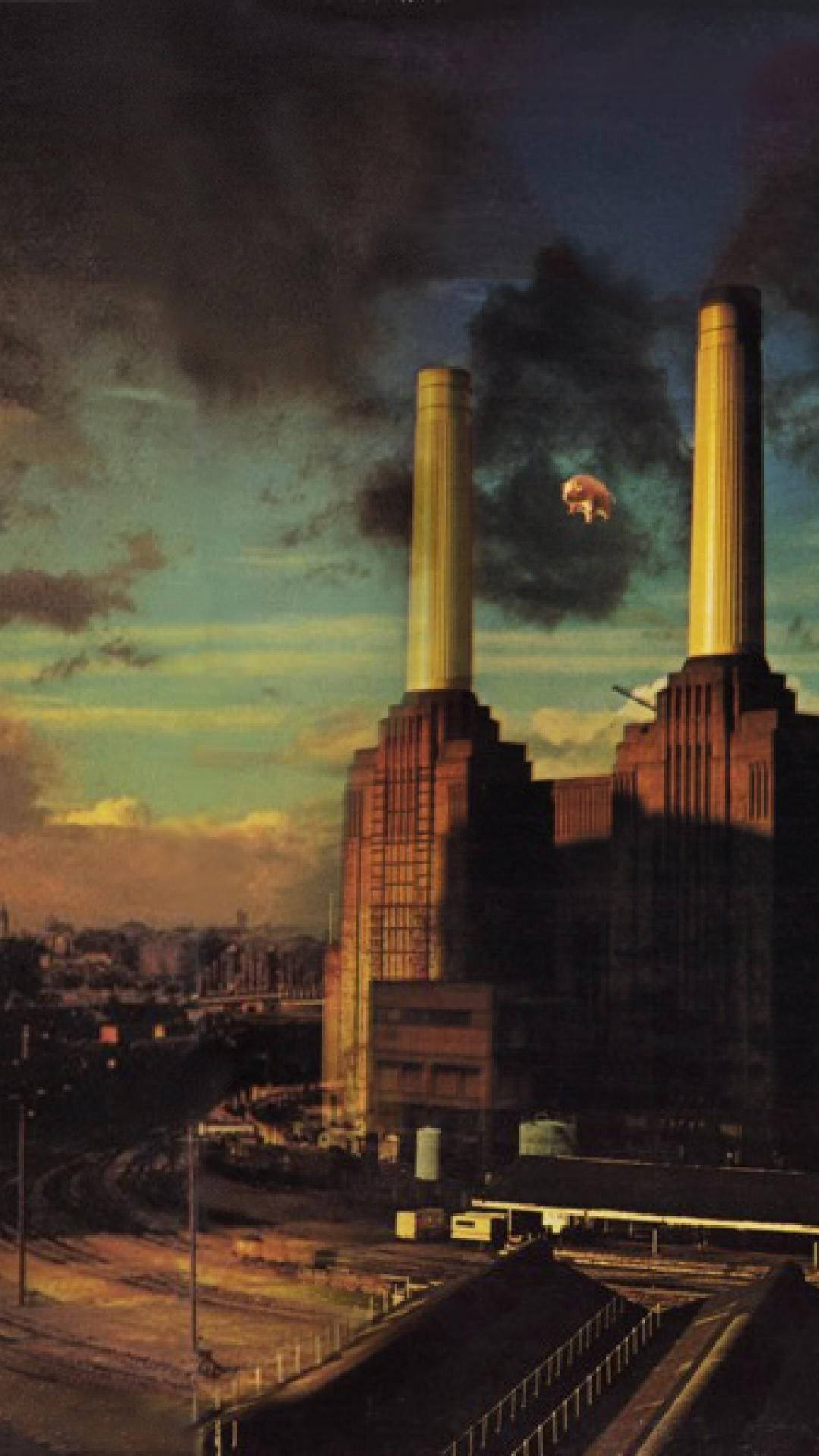 Floyd 桌布 壁紙 — Battersea Power Station 的塔在暮色天空下，有一隻漂浮的豬和煙囪冒出的煙。