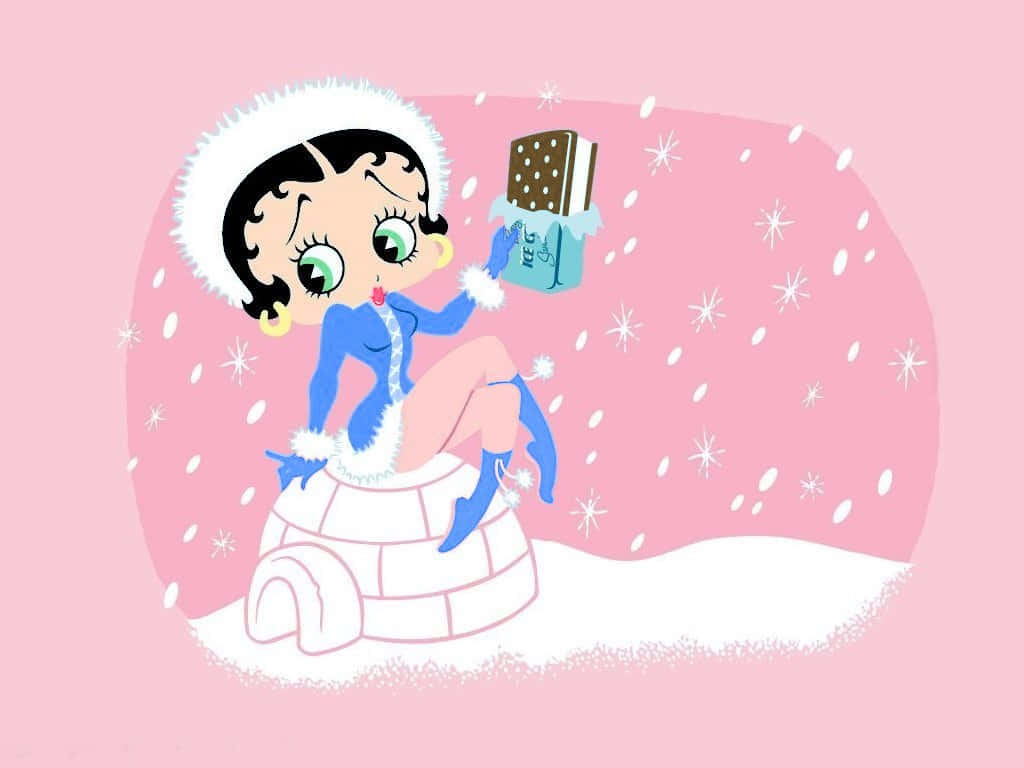 貝蒂娃娃 桌布 壁紙 — Betty Boop 身穿藍色冬季服裝坐在冰屋頂上，手持冰淇淋三明治，雪花在粉紅色背景中飄落。