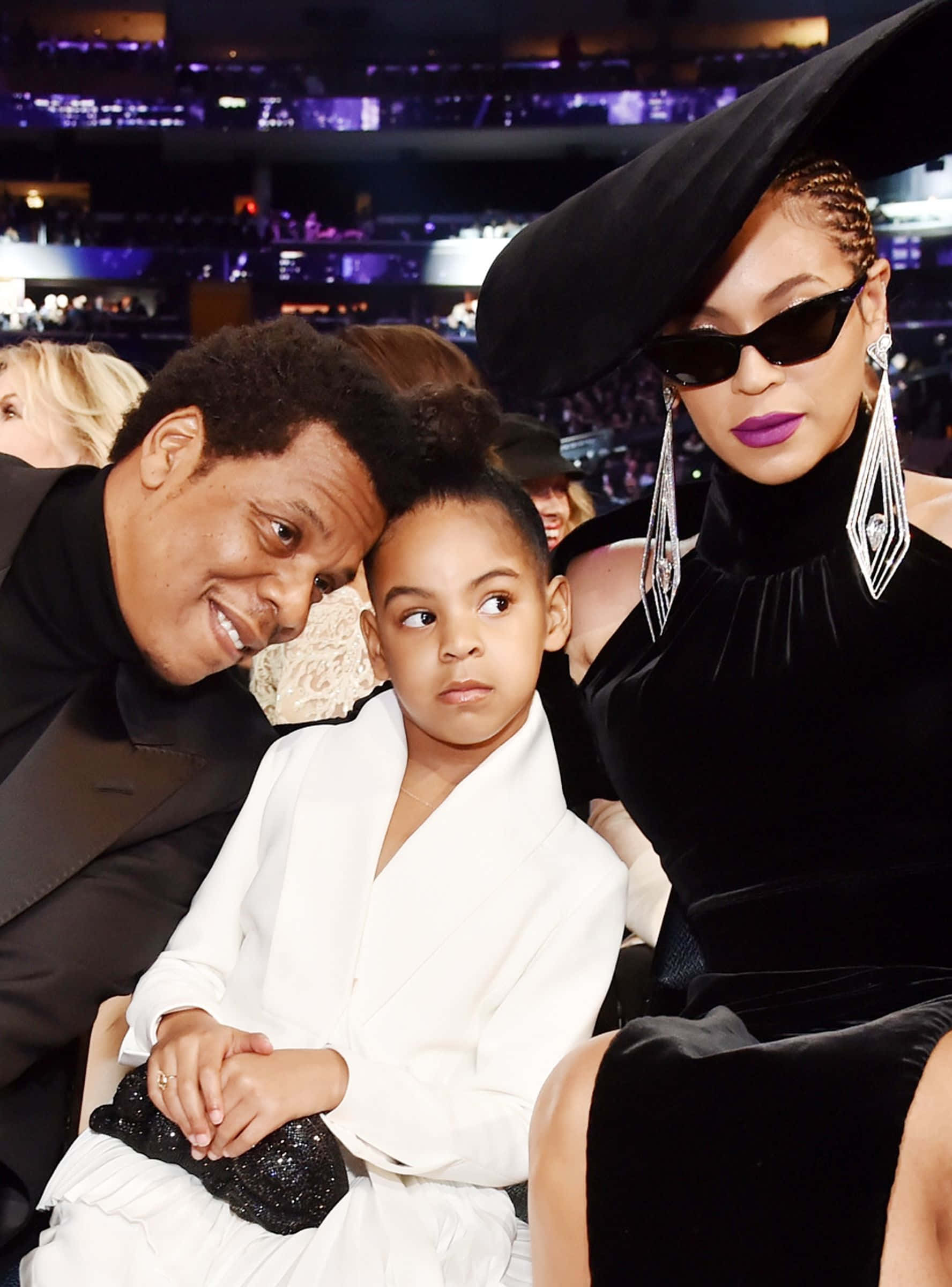 寶寶 桌布 壁紙 — Beyoncé Jay-Z 和他們的女兒 Blue Ivy 在充滿活力的紫色舞台燈光下一起坐在一個華麗的活動中。