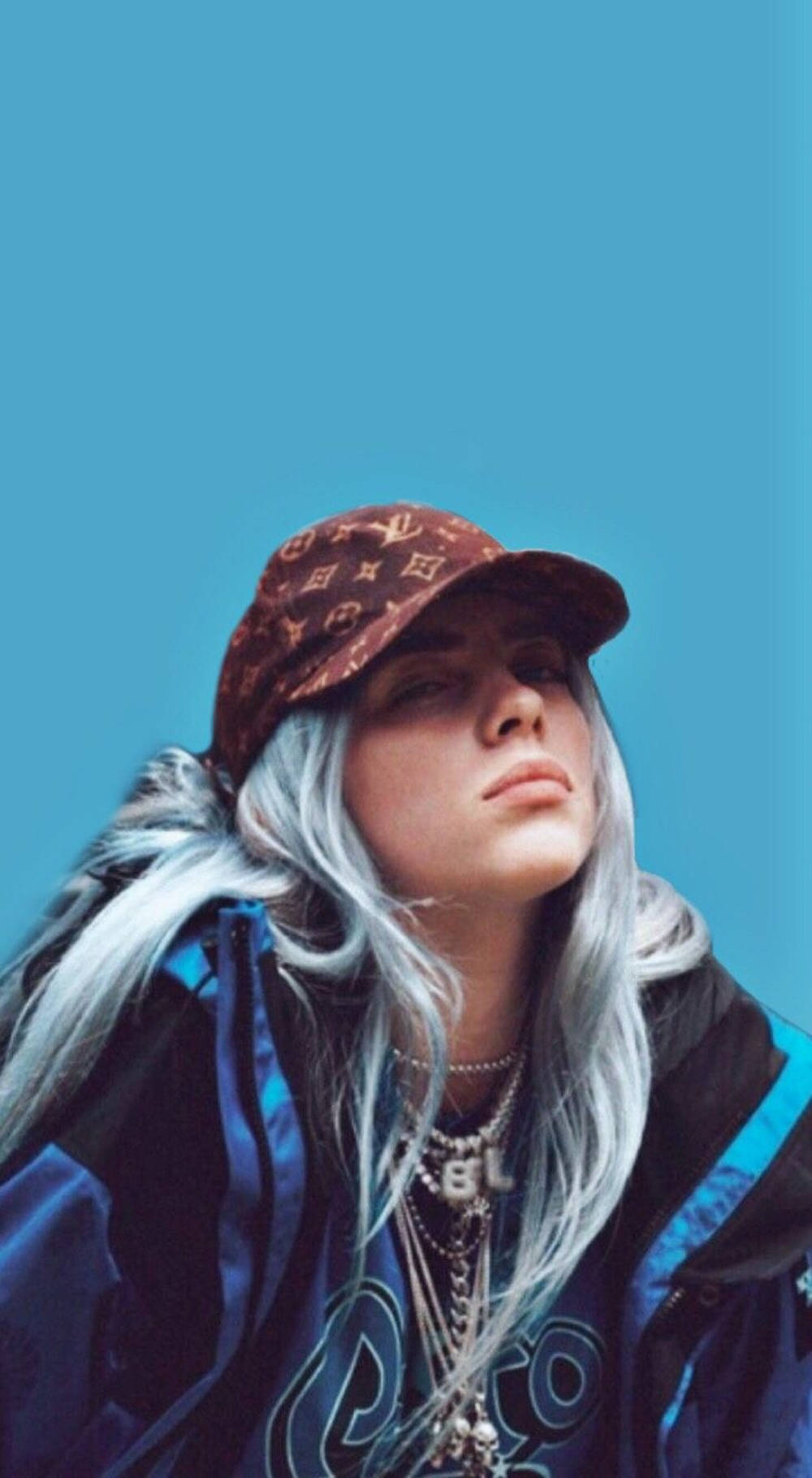 Billie Eilish 戴著帽子和外套，在藍色背景下抬頭仰望。 — 路易威登 GIF 壁紙