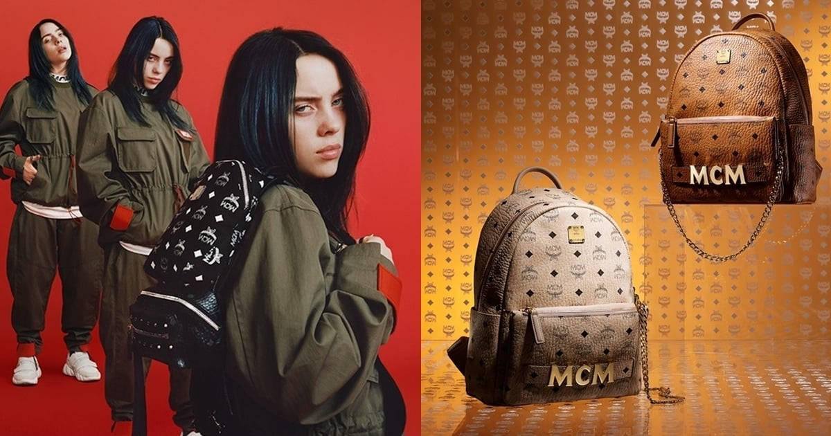 Billie Eilish 身穿橄欖綠色服裝，與 MCM 背包在金色圖案背景上。 — 怪奇比莉 GIF 壁紙