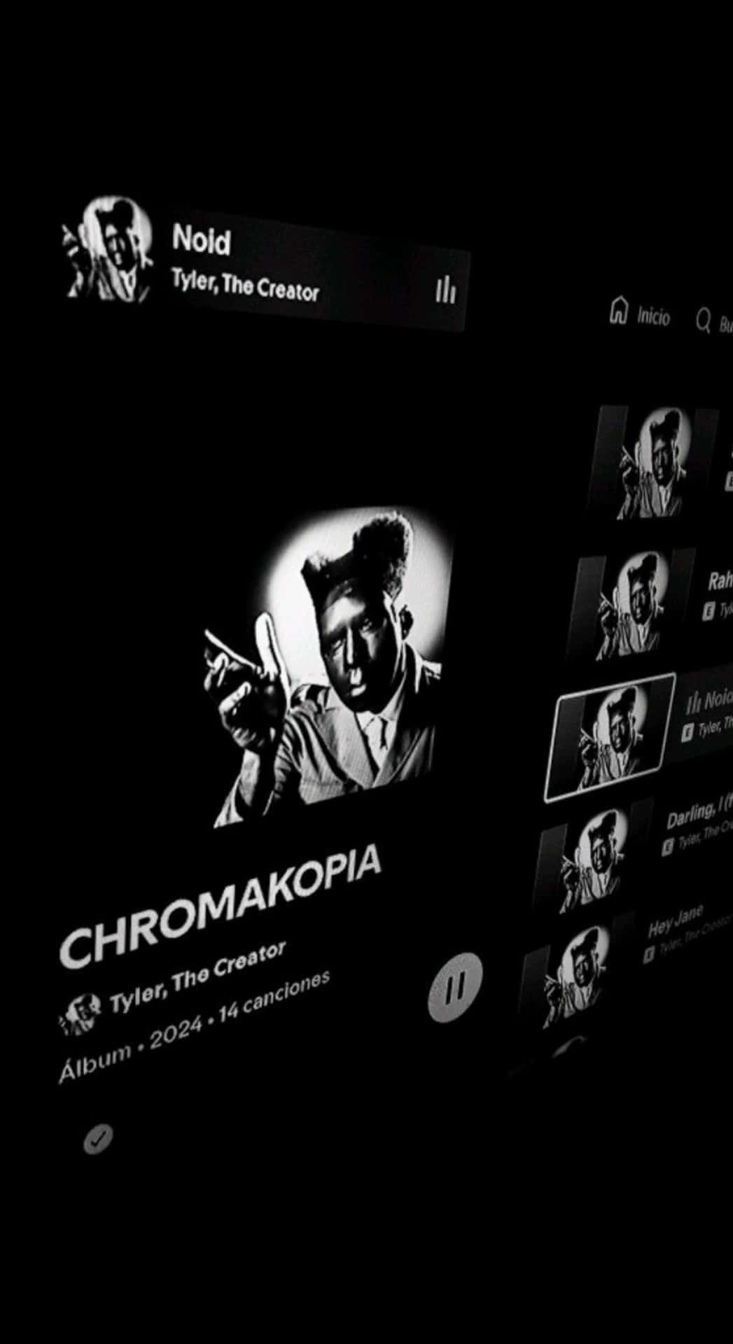  壁紙 — 黑白智慧型手機螢幕顯示 Tyler The Creator 的專輯 Chromakopia，附有藝術家肖像和曲目列表。