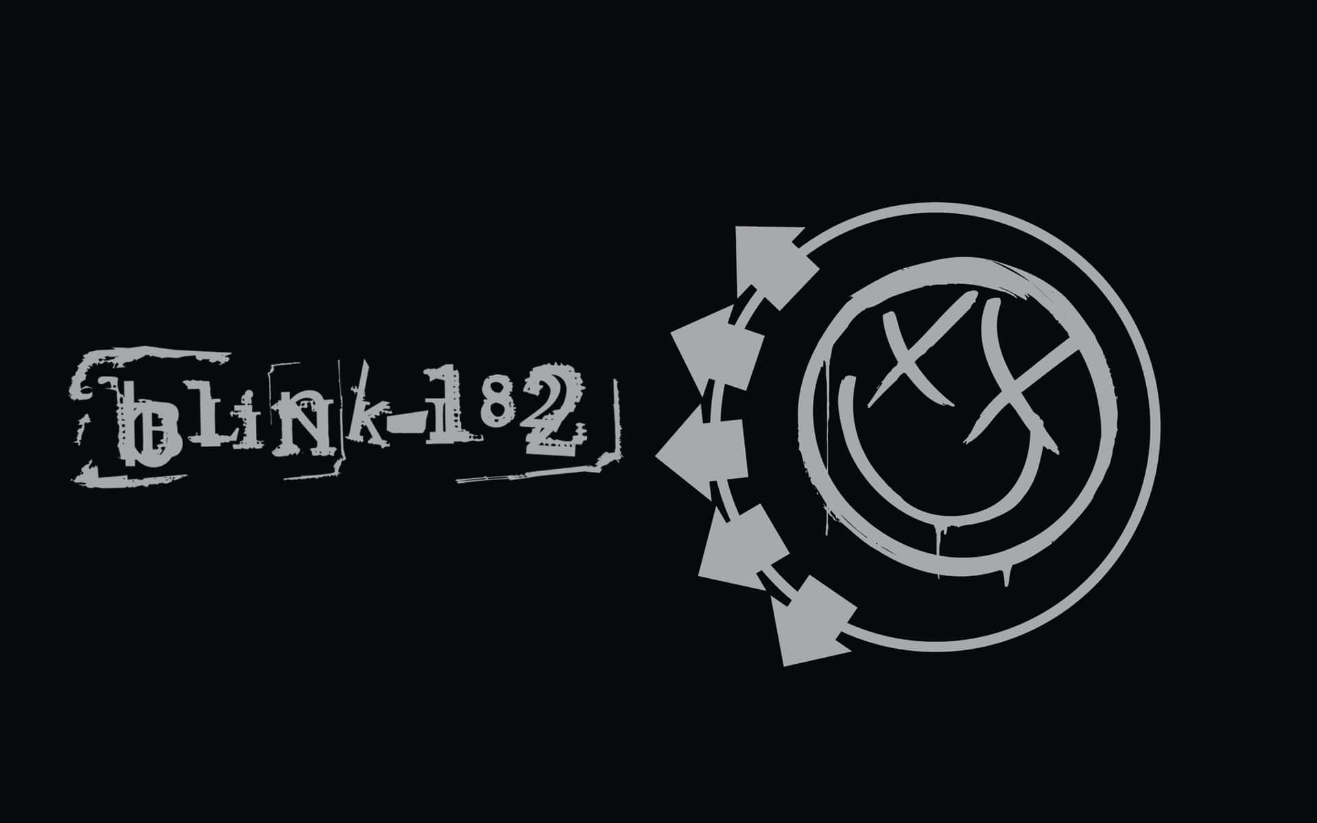  壁紙 — Blink-182 標誌，帶有圓形笑臉和箭頭，背景為黑色。