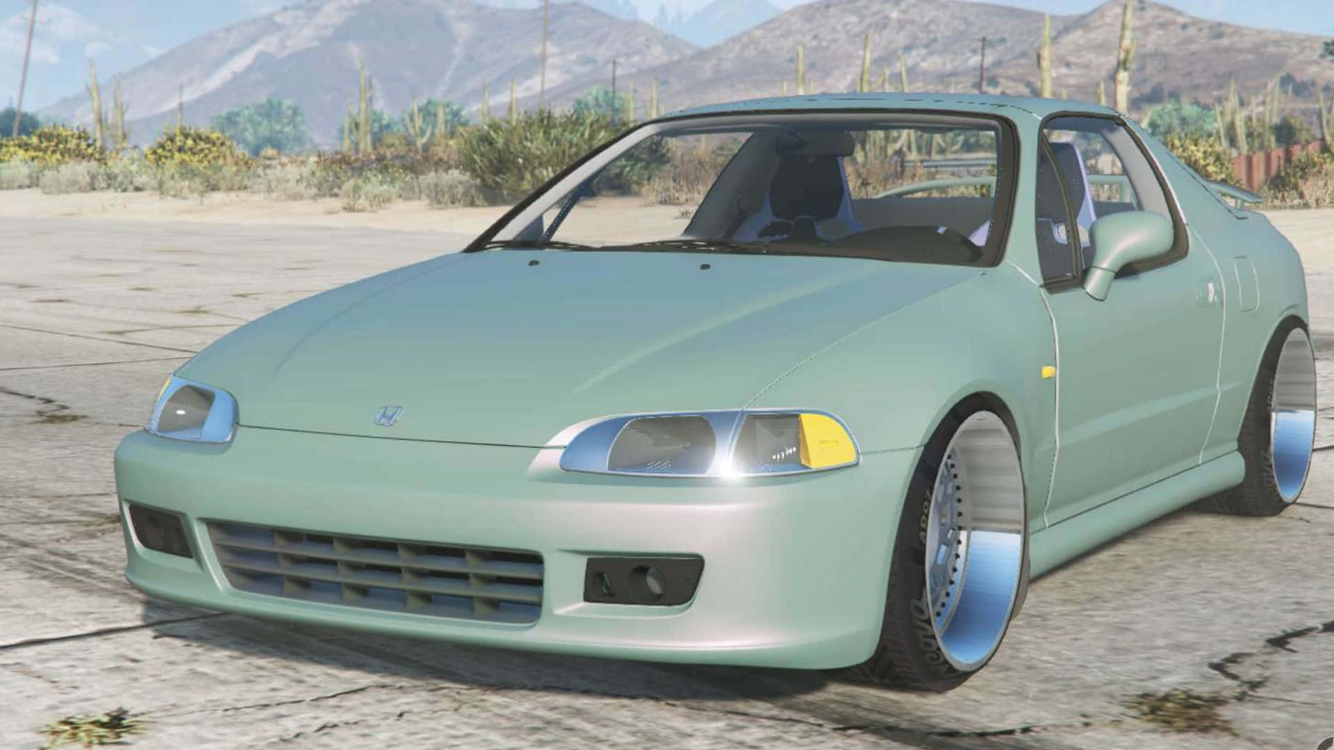 Honda Civic Del Sol 桌布 壁紙 — 一輛薄荷綠色的本田S2000跑車配備客製化輪圈，停在裂開的路面上，背景是沙漠景觀，有山脈和仙人掌。
