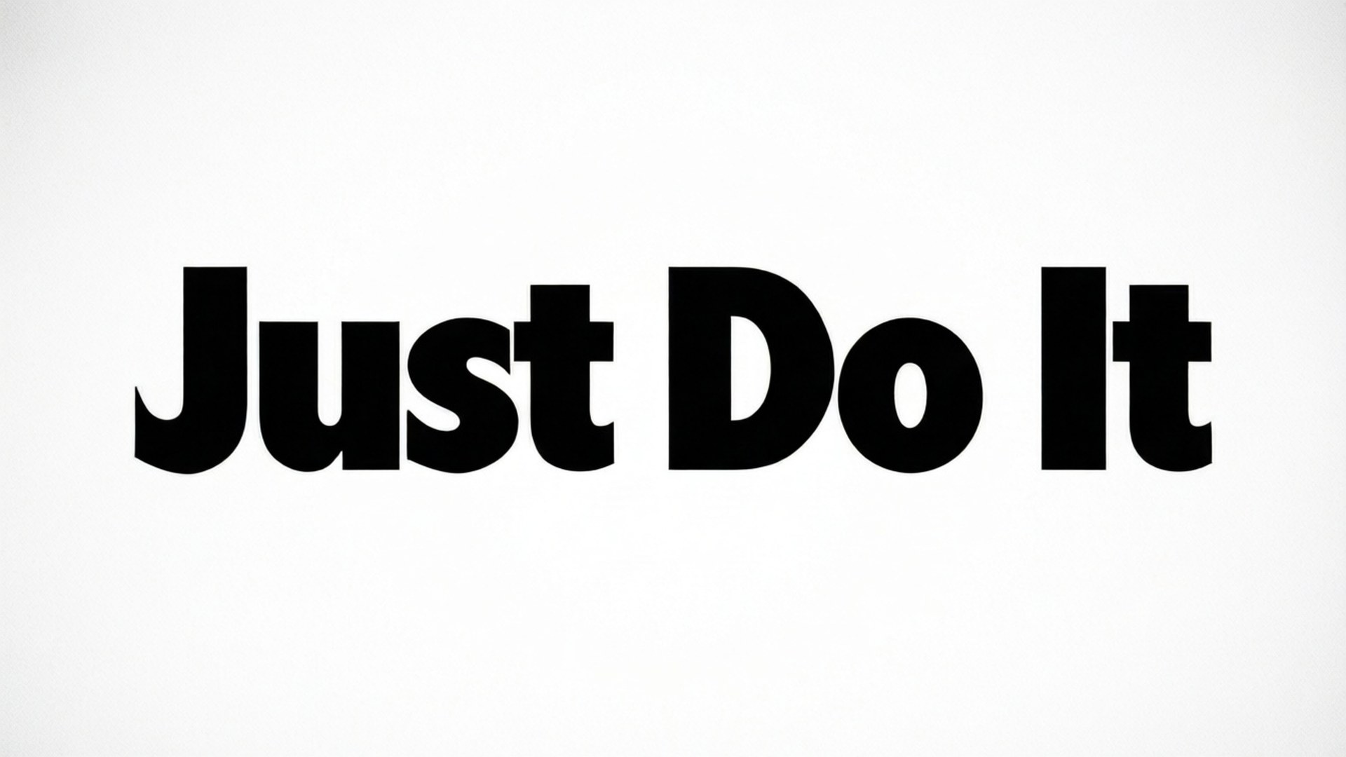 就去做吧 桌布 壁紙 — 粗體黑色「Just Do It」文字居中於純白背景上，搭配簡潔極簡字體設計。
