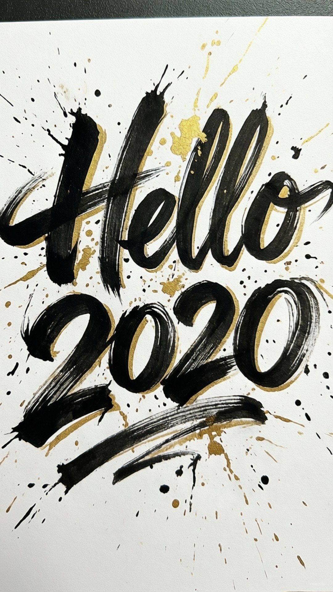 Brush Script Hello 壁紙 — 粗體筆觸文字在白色背景上以黑色和金色潑濺顯示 hello 2020。