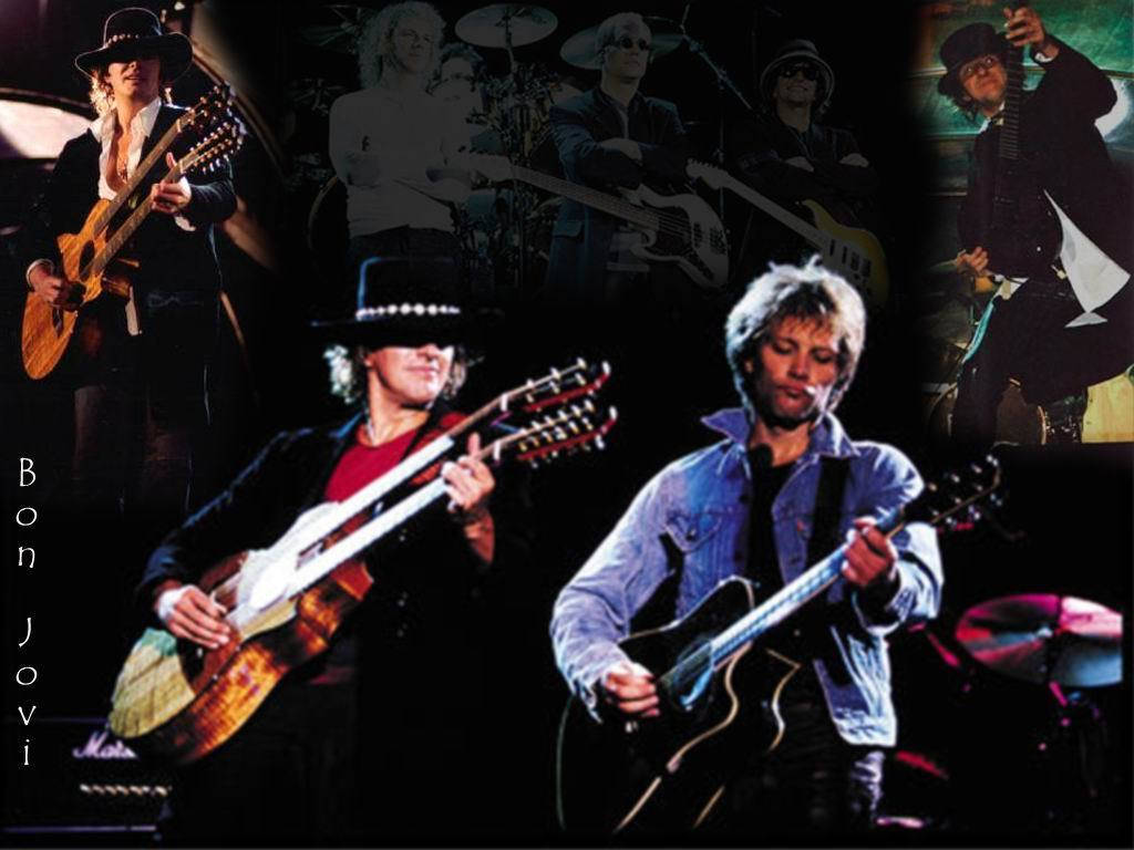 Rockstar 桌布 壁紙 — Bon Jovi 樂團成員在戲劇性的舞台燈光下，手持吉他現場表演。