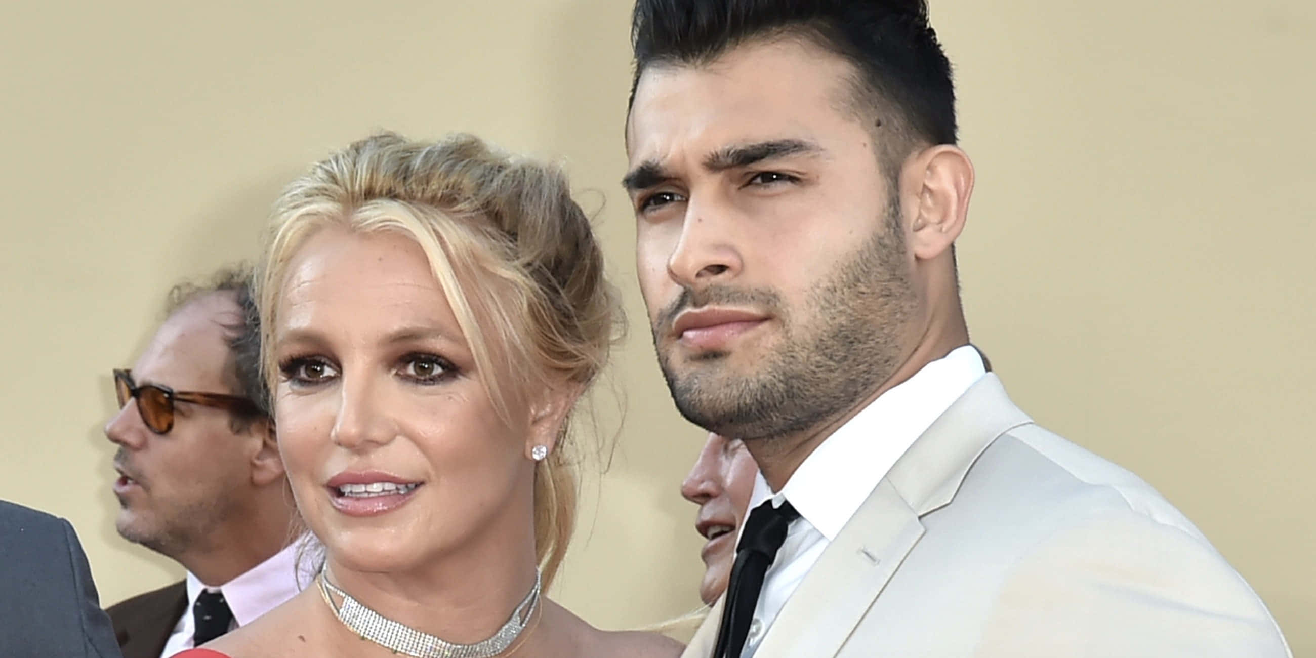 Britney Spears 桌布 壁紙 — Britney Spears 和 Sam Asghari 在華麗的紅地毯活動中穿著正式服裝一起擺姿勢。
